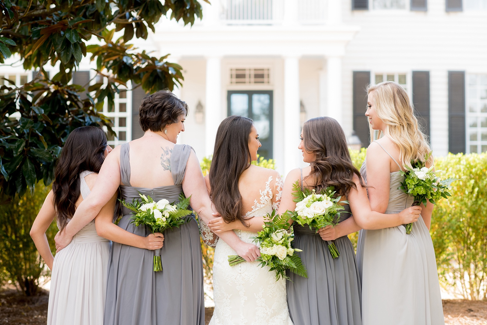 The Sutherland Wedding Photos by Mikkel Paige Photography. Back vogue-like bridal party picture with the bride in lace Pronovias and bridesmaids party in various shades of grey gowns. Planning by A Southern Soiree.