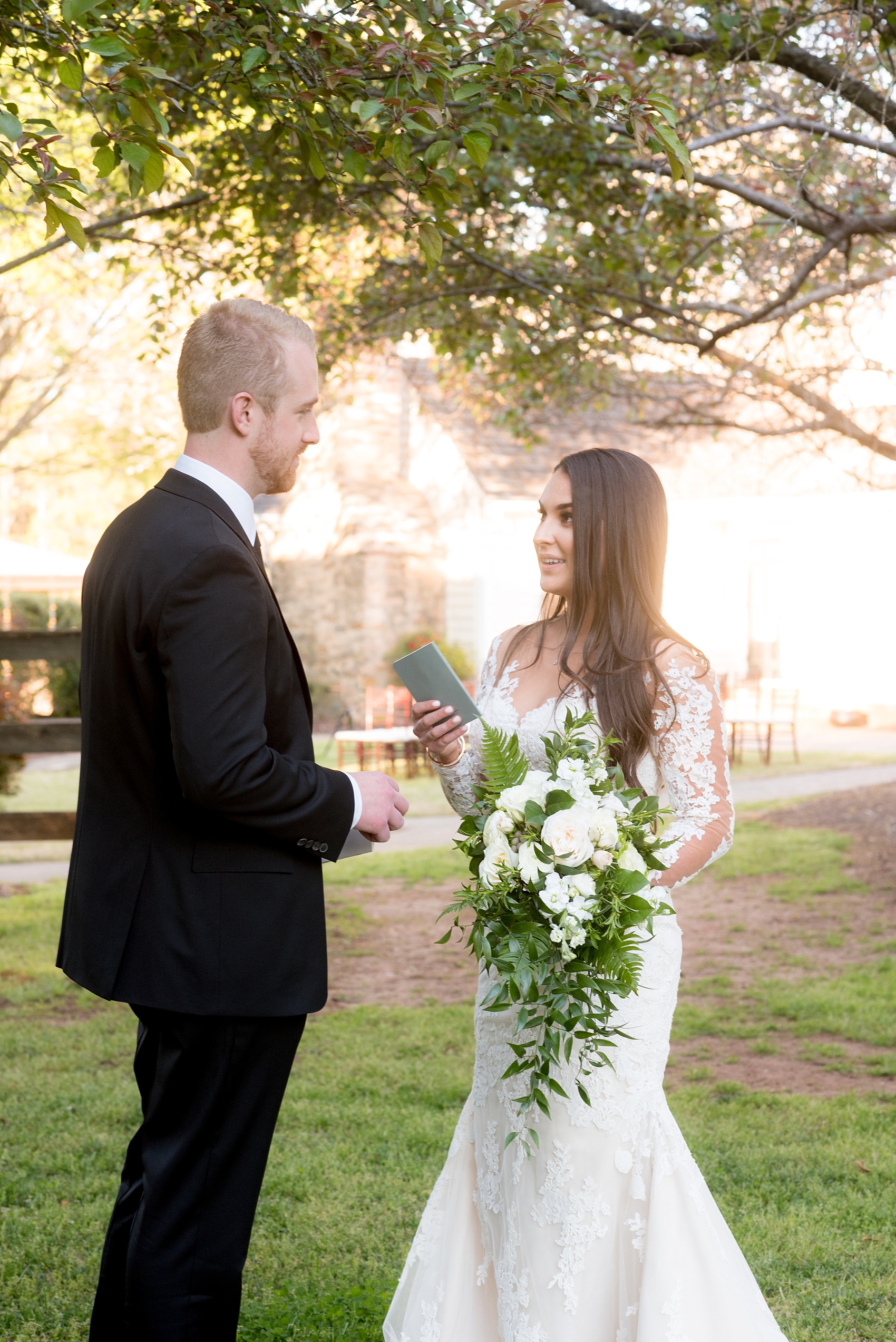 The Sutherland Wedding Photos by Mikkel Paige Photography. The bride in a long-sleeve lace Pronovias gown and groom in black suit, exchange vows privately.