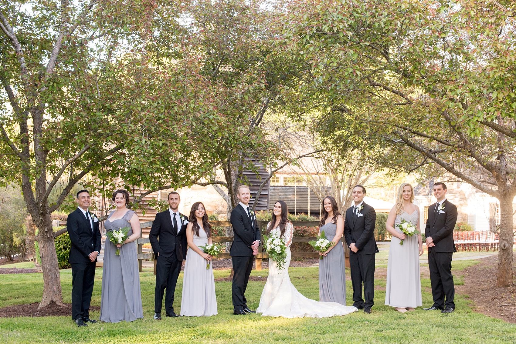 The Sutherland Wedding Photos by Mikkel Paige Photography. Vogue like wedding party picture with the bride in lace Pronovias and bridal party in grey gowns. Planning by A Southern Soiree.