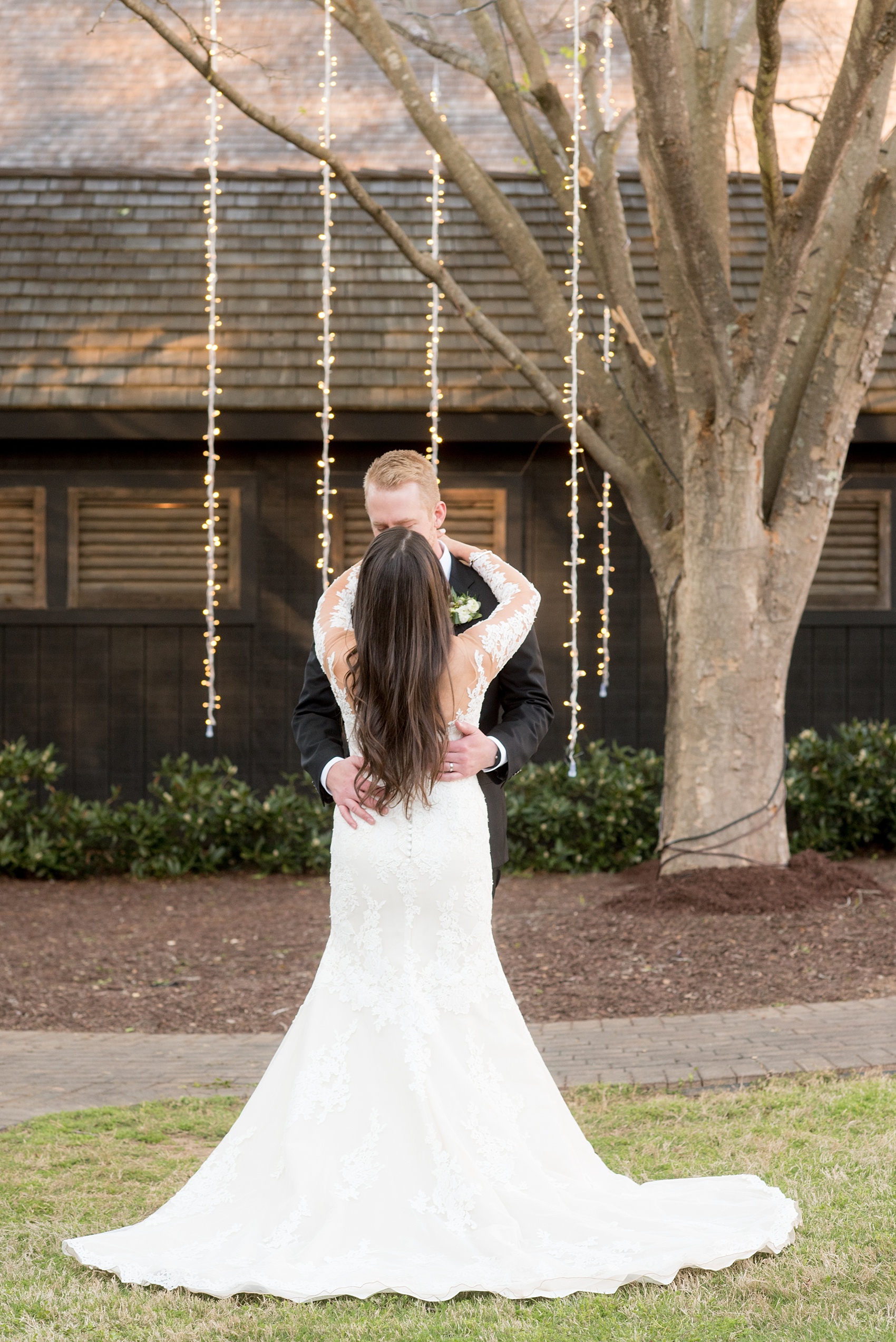 The Sutherland Wedding Photos by Mikkel Paige Photography. Bride and groom picture with a lace Pronovias gown and classic black tuxedo. Planning by A Southern Soiree.