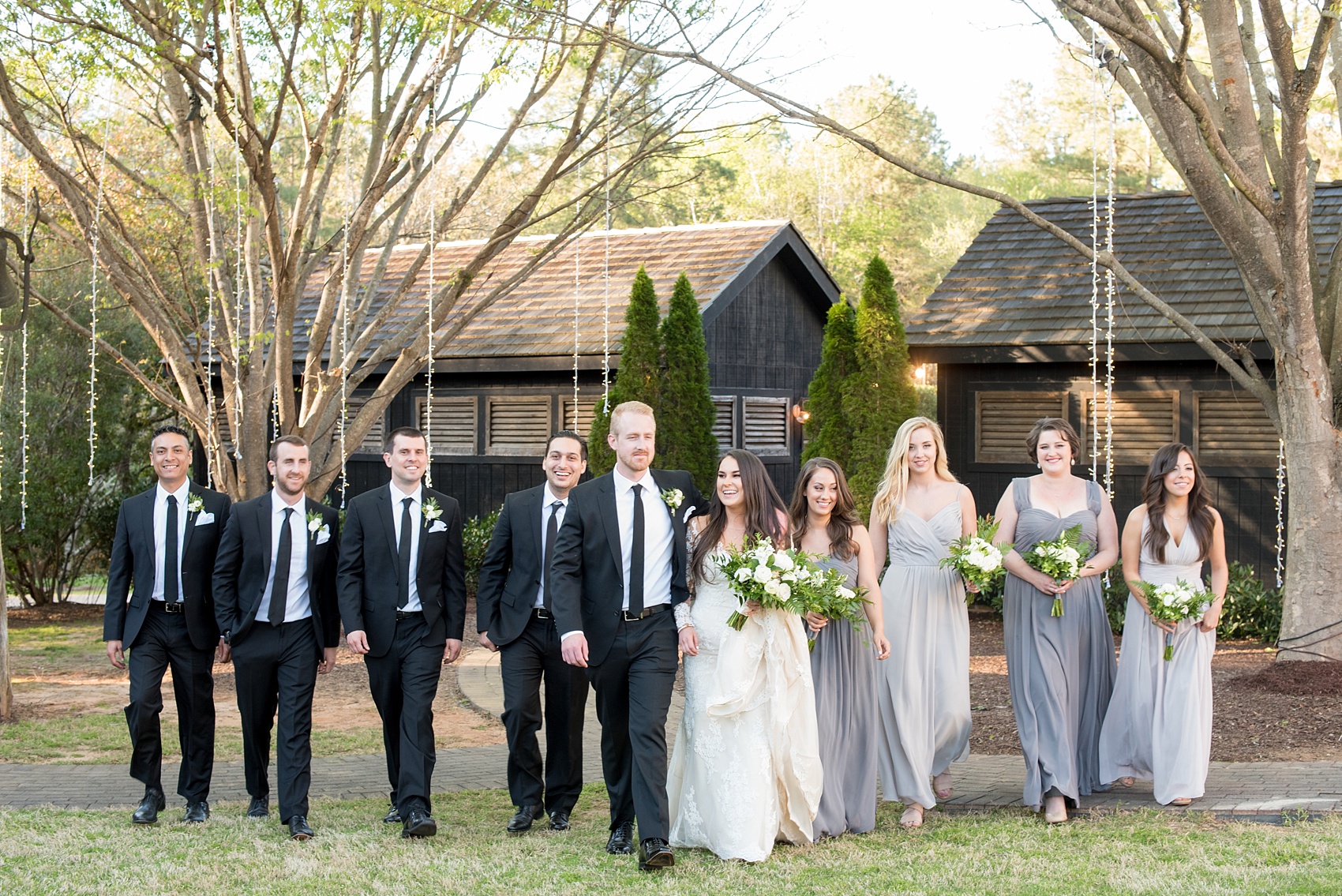The Sutherland Wedding Photos by Mikkel Paige Photography. Wedding party picture with the bride in lace Pronovias and bridal party in grey gowns.