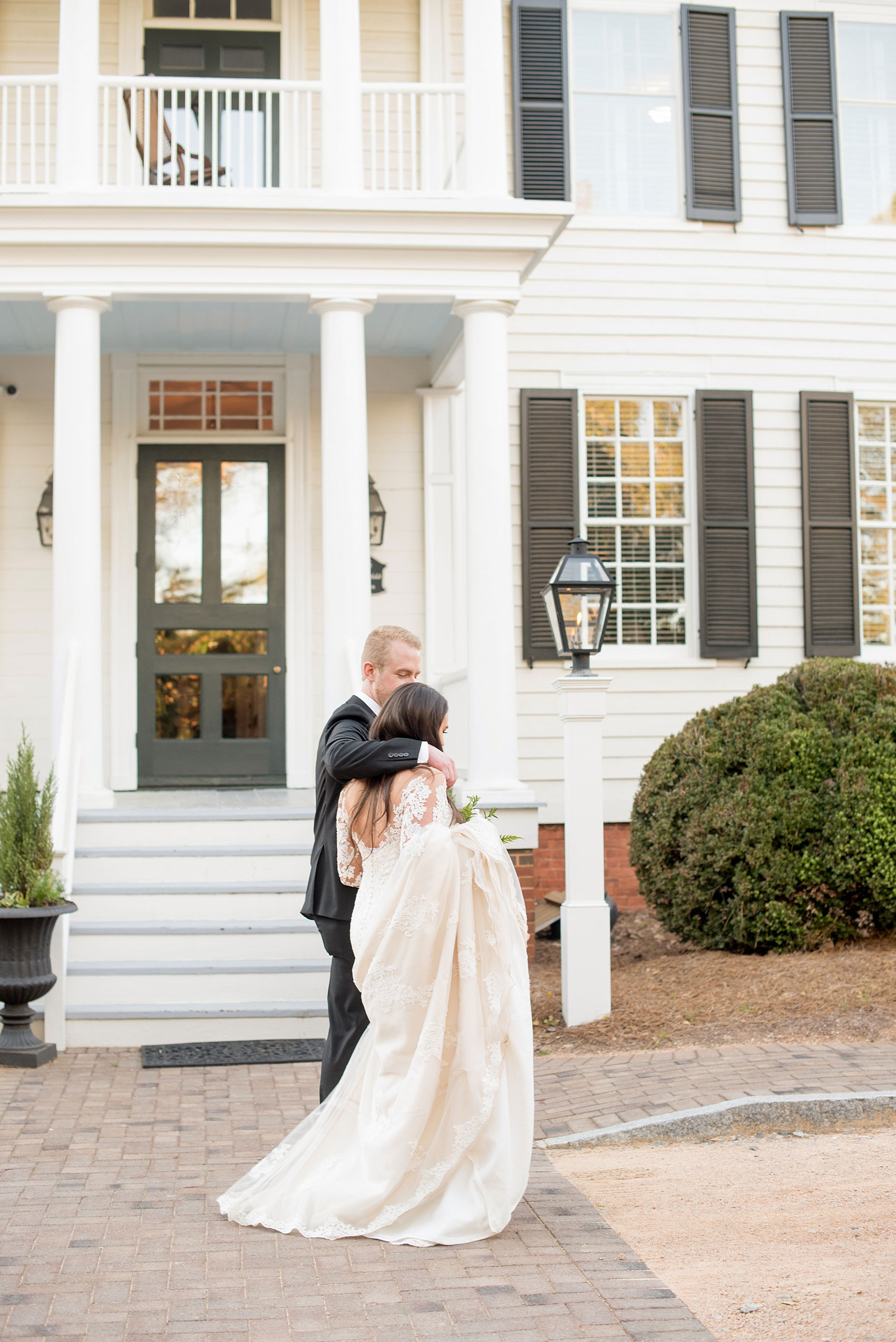 The Sutherland Wedding Photos by Mikkel Paige Photography. Bride and groom candid photo as they pass their southern home venue and go to their outdoor cocktail hour.