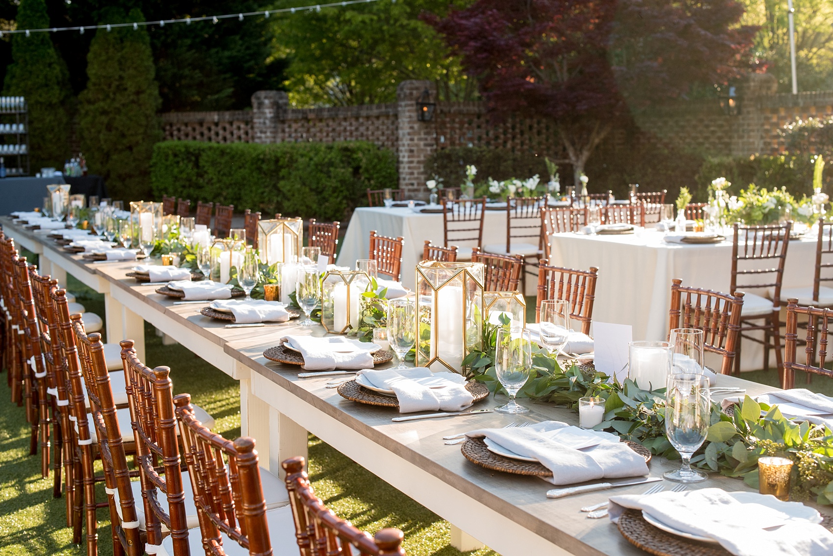 The Sutherland Wedding Photos by Mikkel Paige Photography. Grey and white farm tables by Cottage Luxe, with gold geometric candle holders, eucalyptus leaf garland and wooden chargers. Planning by A Southern Soiree.