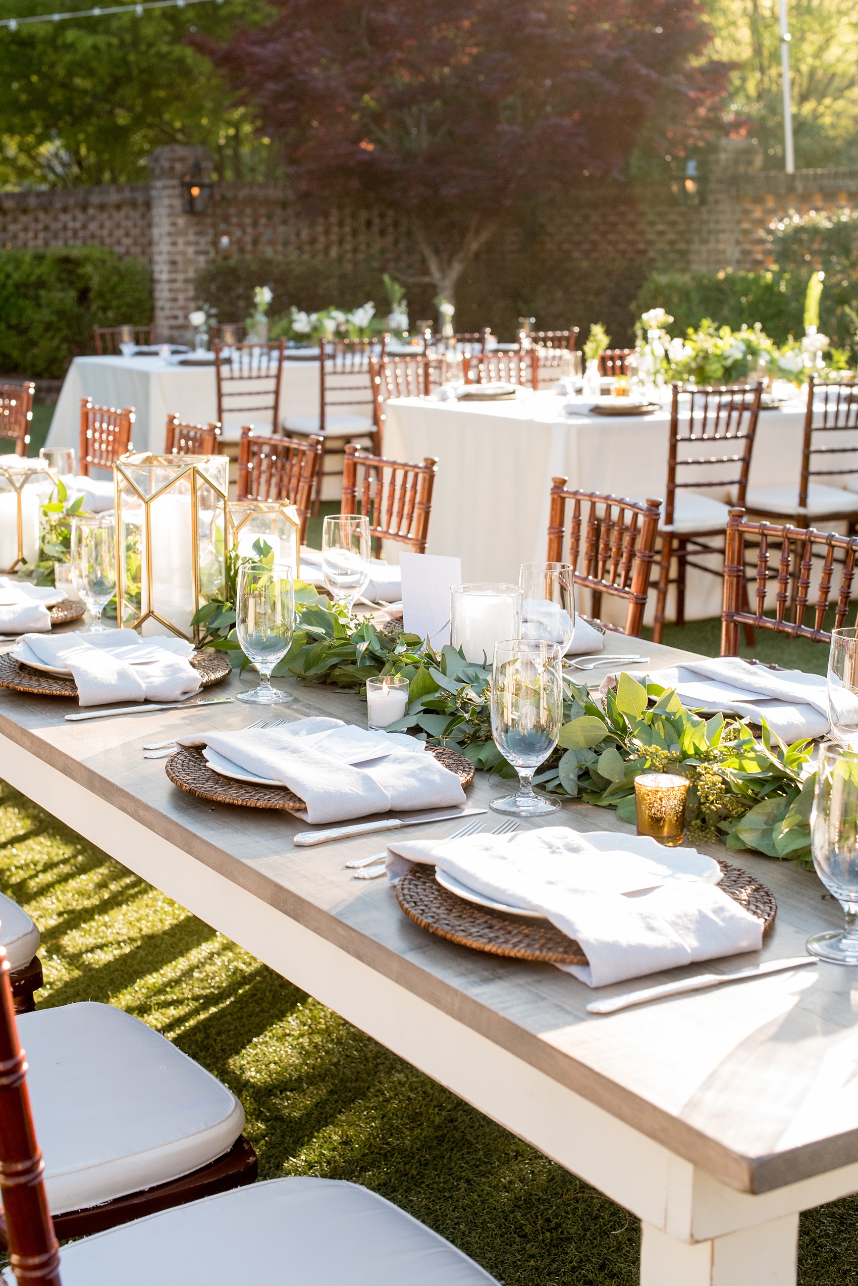 The Sutherland Wedding Photos by Mikkel Paige Photography. Grey and white farm tables by Cottage Luxe, with gold geometric candle holders, eucalyptus leaf garland and wooden chargers. Planning by A Southern Soiree.