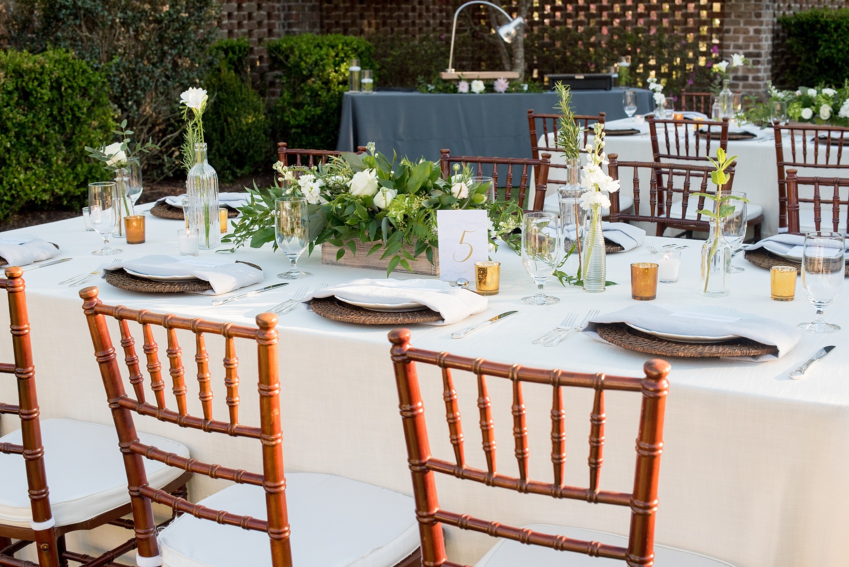 The Sutherland Wedding Photos by Mikkel Paige Photography. Grey and white farm tables by Cottage Luxe, with wooden flower boxes by Eclectic Sage. Planning by A Southern Soiree.