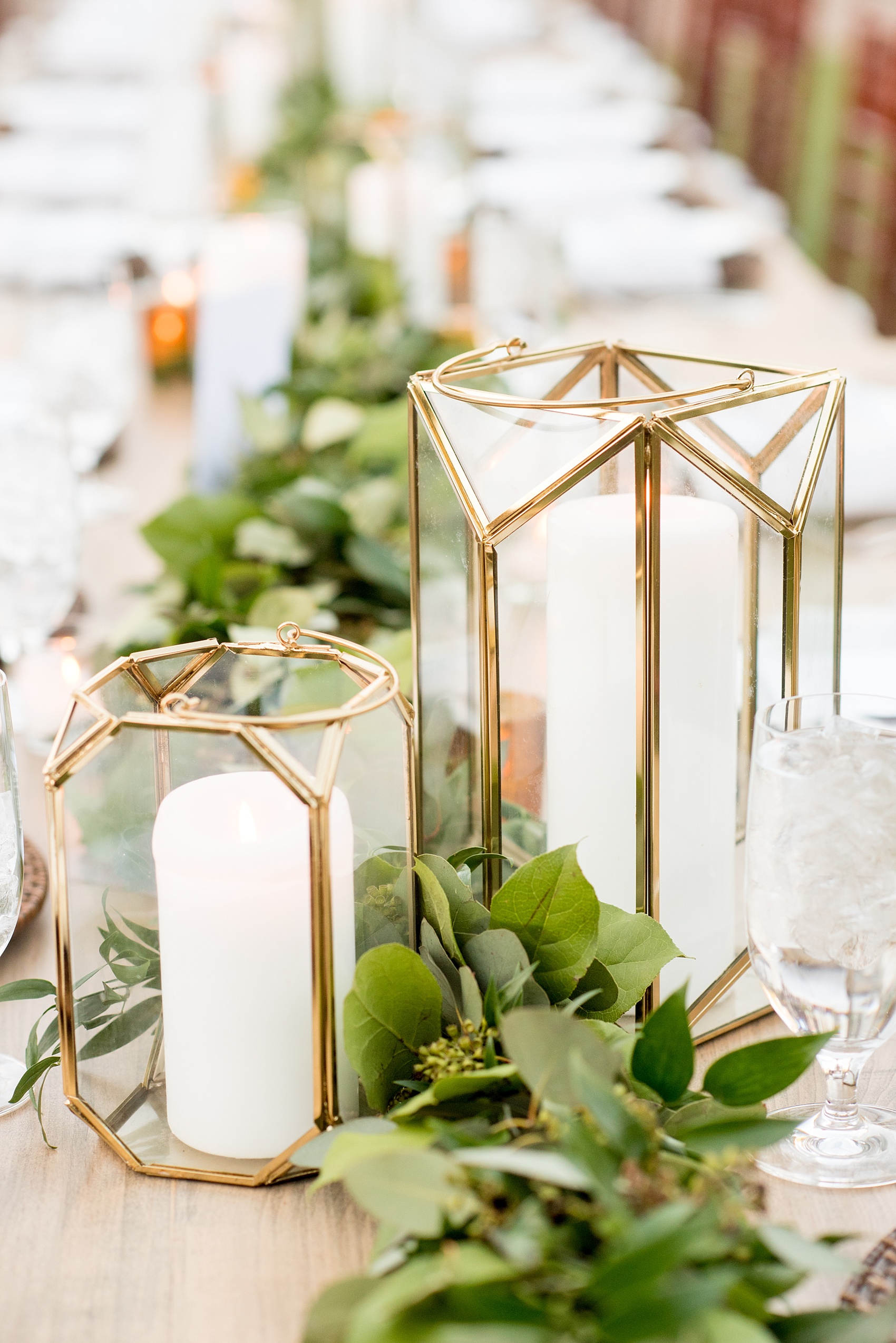 The Sutherland Wedding Photos by Mikkel Paige Photography. Grey and white farm tables by Cottage Luxe, with gold geometric candle holders and eucalyptus leaf garland. Planning by A Southern Soiree.