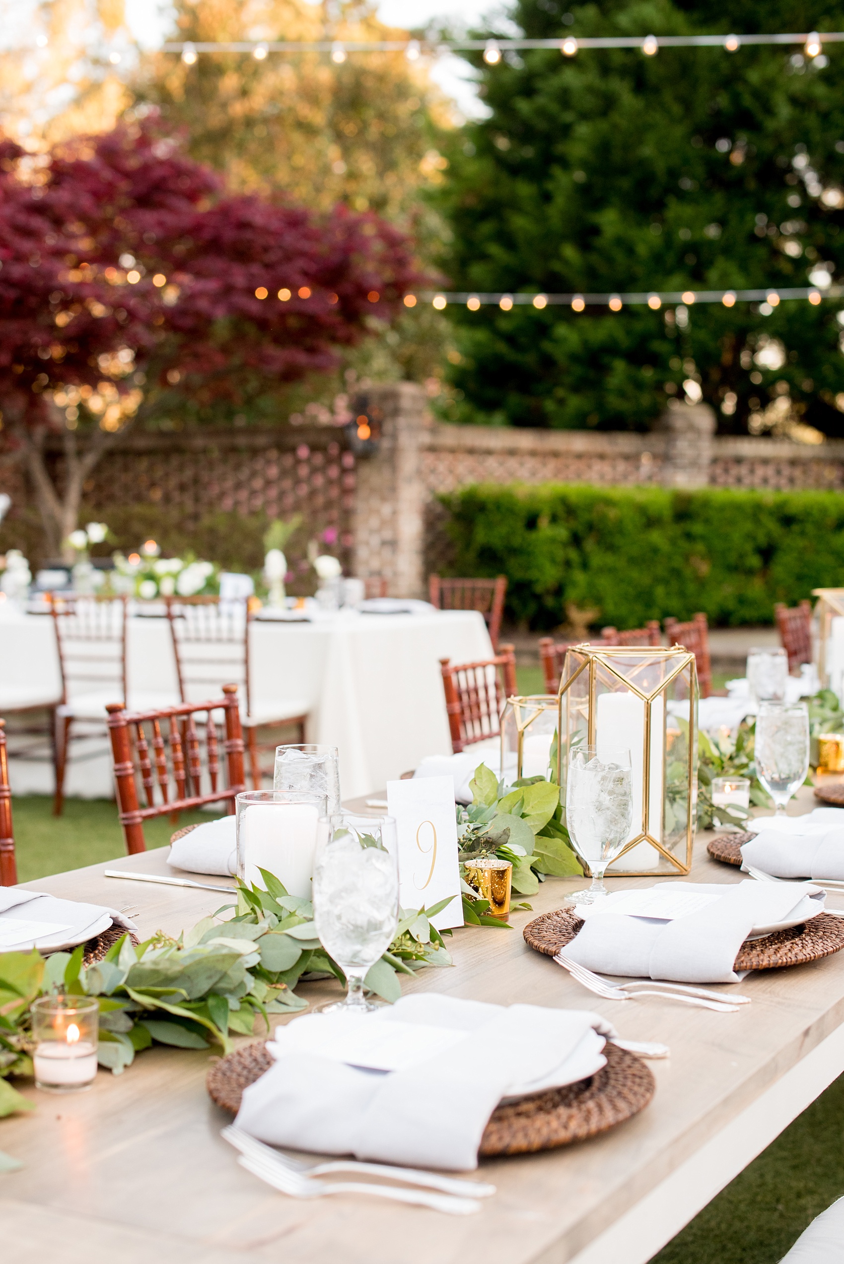 The Sutherland Wedding Photos by Mikkel Paige Photography. Grey and white farm tables by Cottage Luxe, with gold geometric candle holders and market lights. Planning by A Southern Soiree.