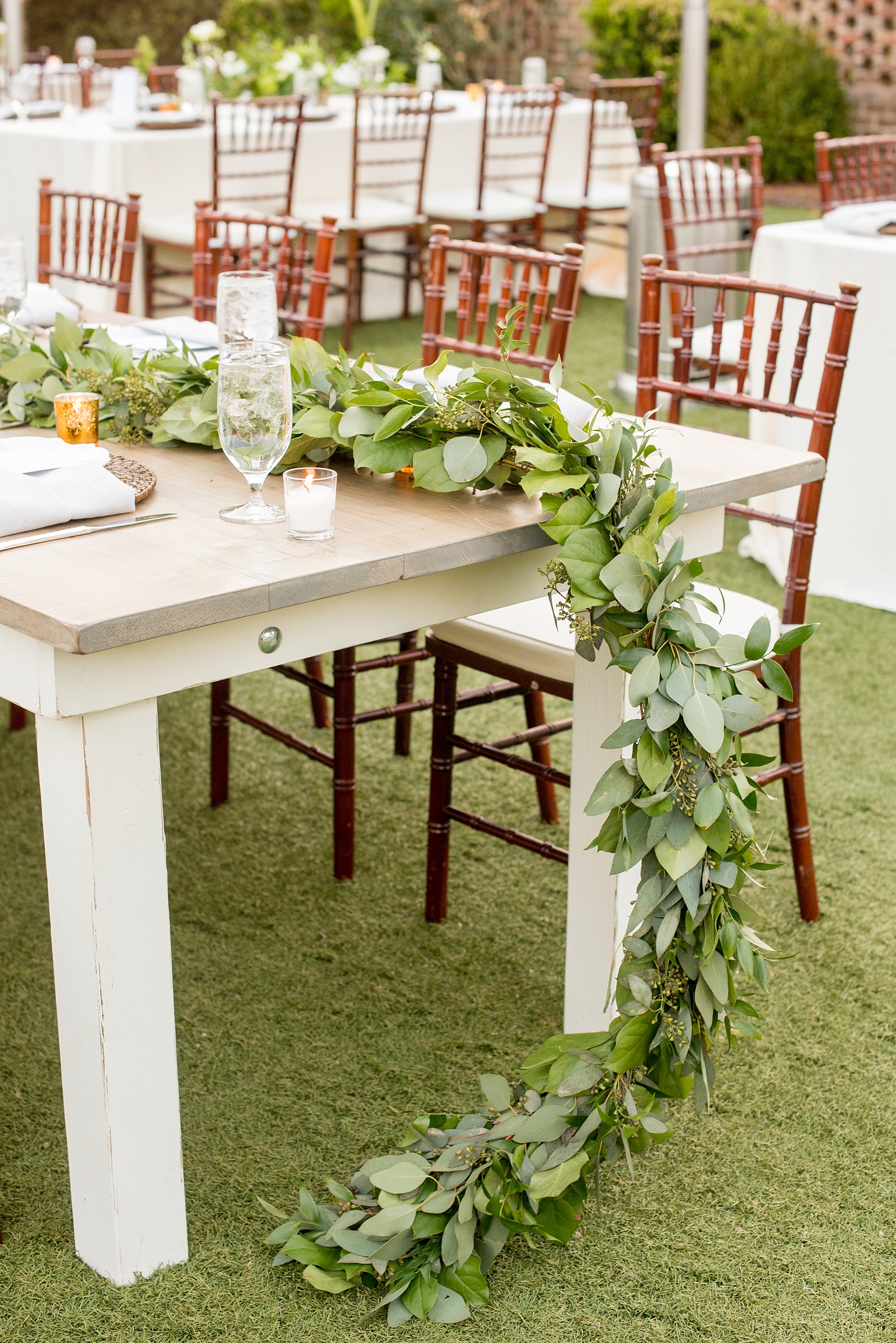 The Sutherland Wedding Photos by Mikkel Paige Photography. Eucalyptus garland detail by Eclectic Sage on grey and white farm tables by Cottage Luxe.