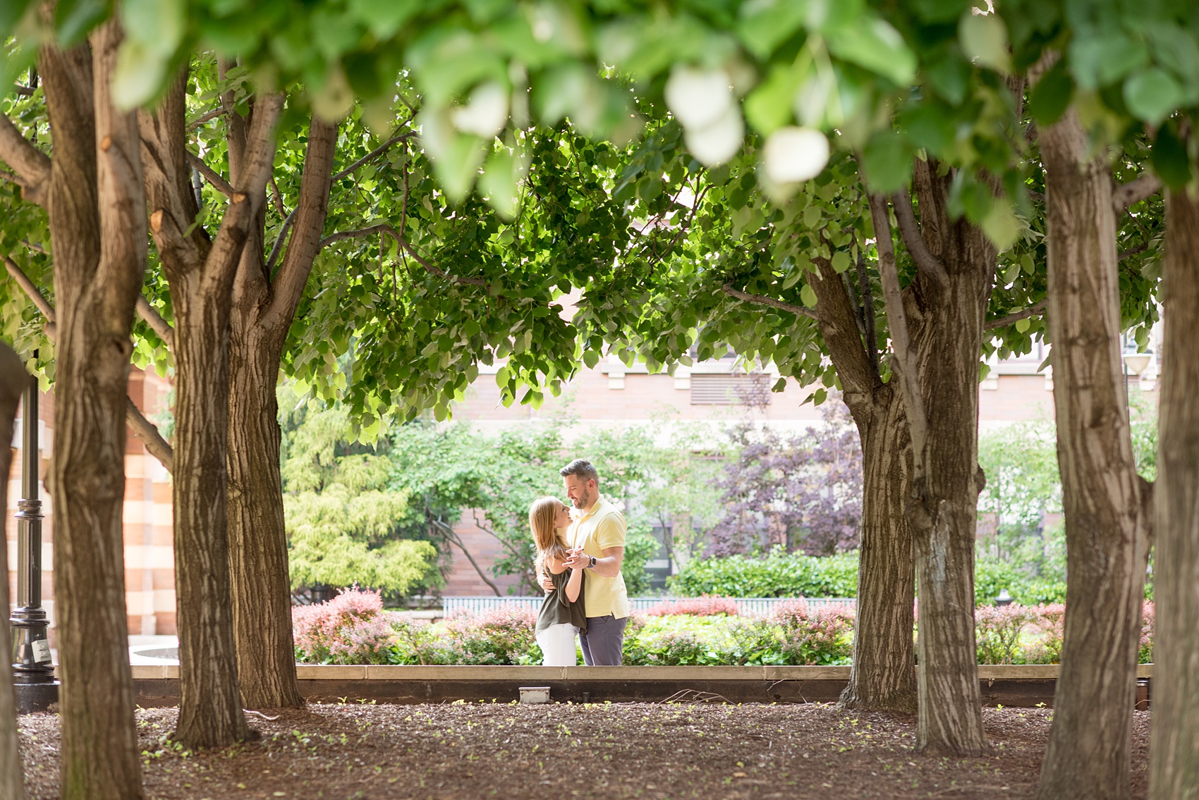Spring Hoboken Engagement Photos by Mikkel Paige Photography with the couple under the trees.
