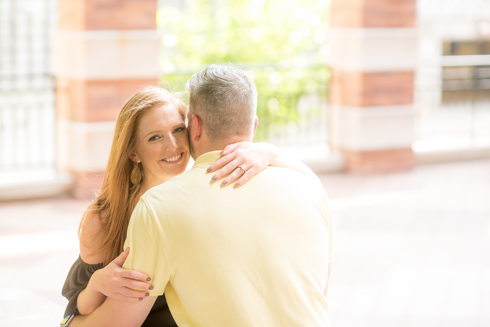 Spring Hoboken Engagement Photos by Mikkel Paige Photography. Picture of the bride and groom embracing in a garden.