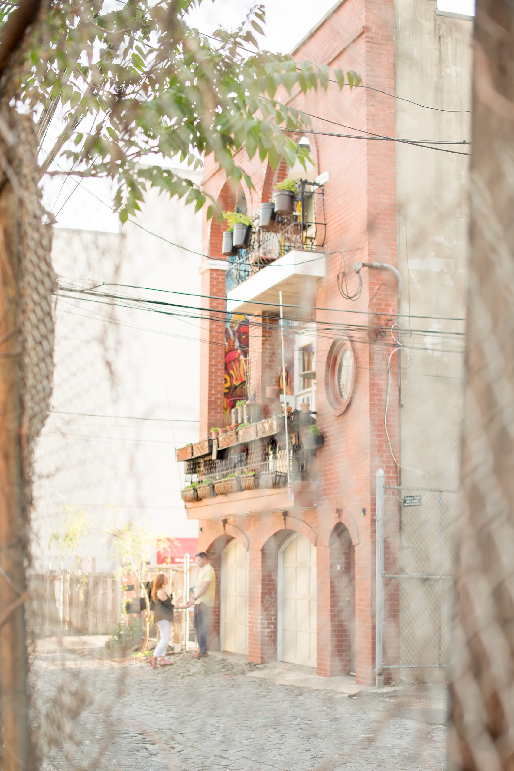 Spring Hoboken Engagement Photos by Mikkel Paige Photography. Picture of the bride and groom in their urban neighborhood.