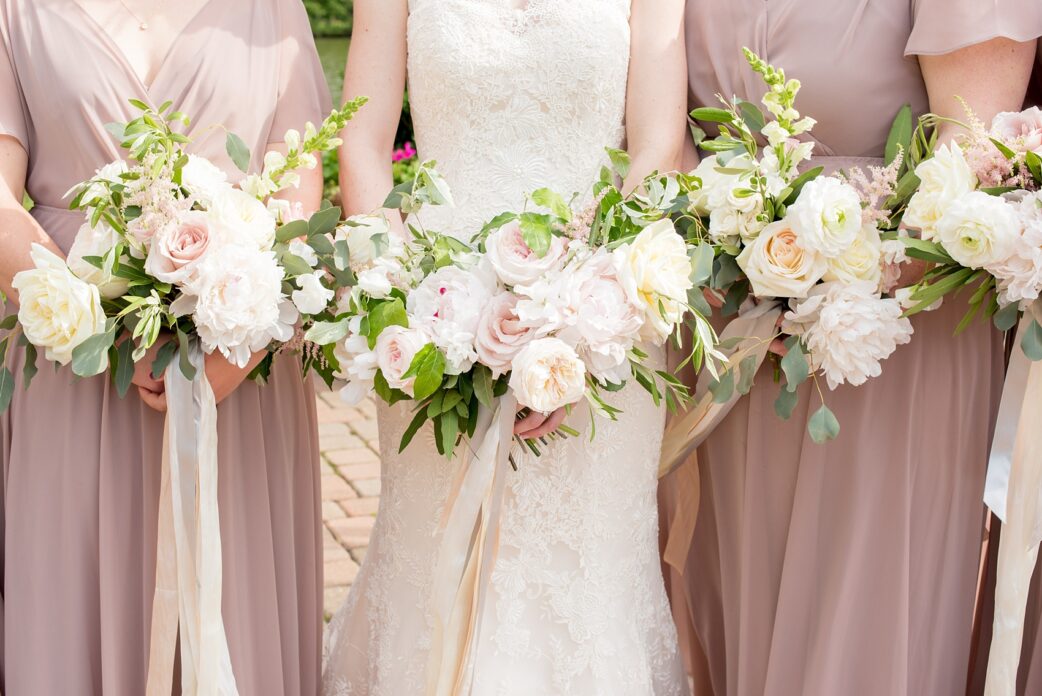 The Pavilion at Angus Barn wedding photos by Mikkel Paige Photography. Flowers by Meristem Floral with bridesmaids in mauve, dusty rose gowns.