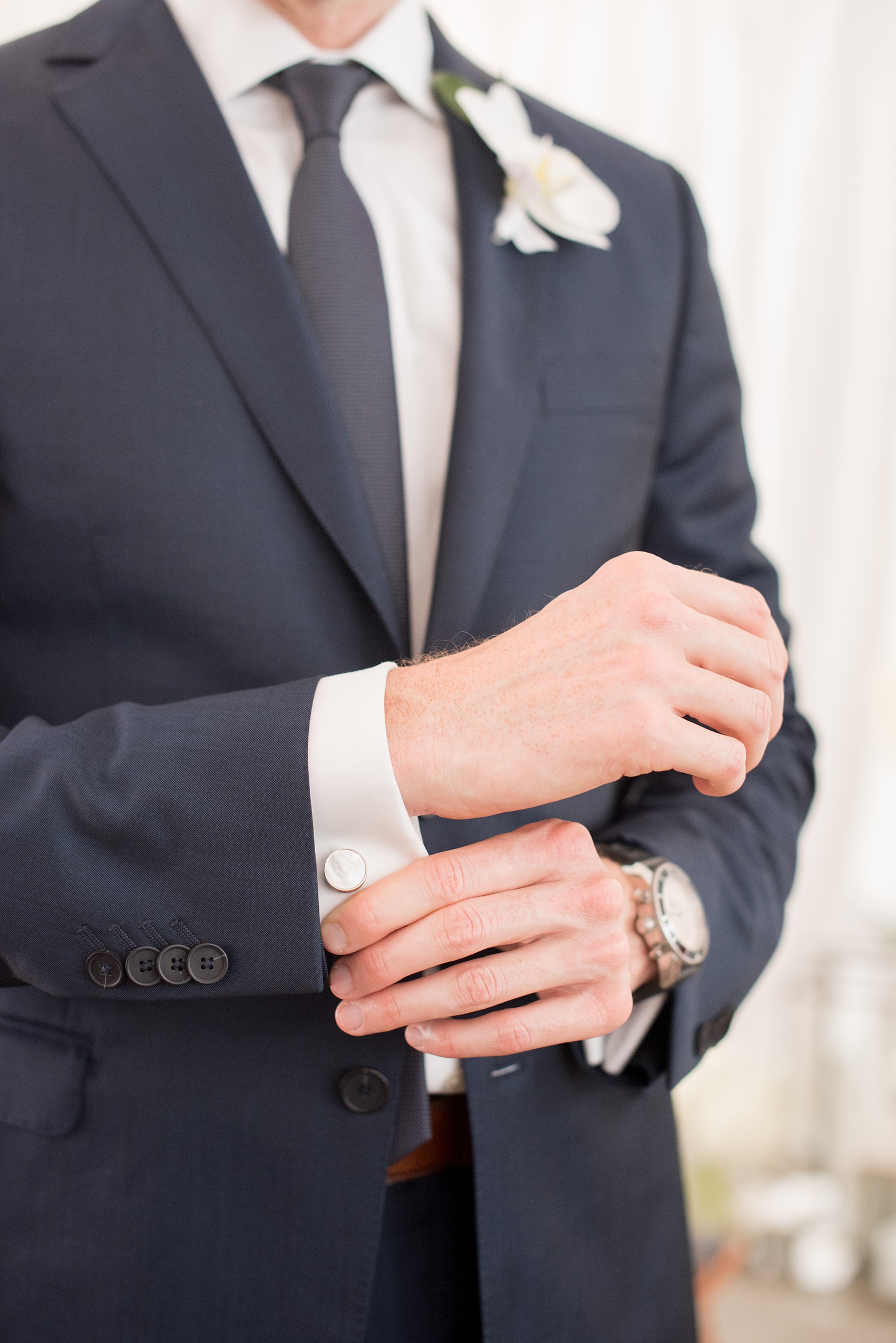 The Cookery Durham wedding photos by Mikkel Paige Photography. Picture of the groom's white cufflinks and navy suit.