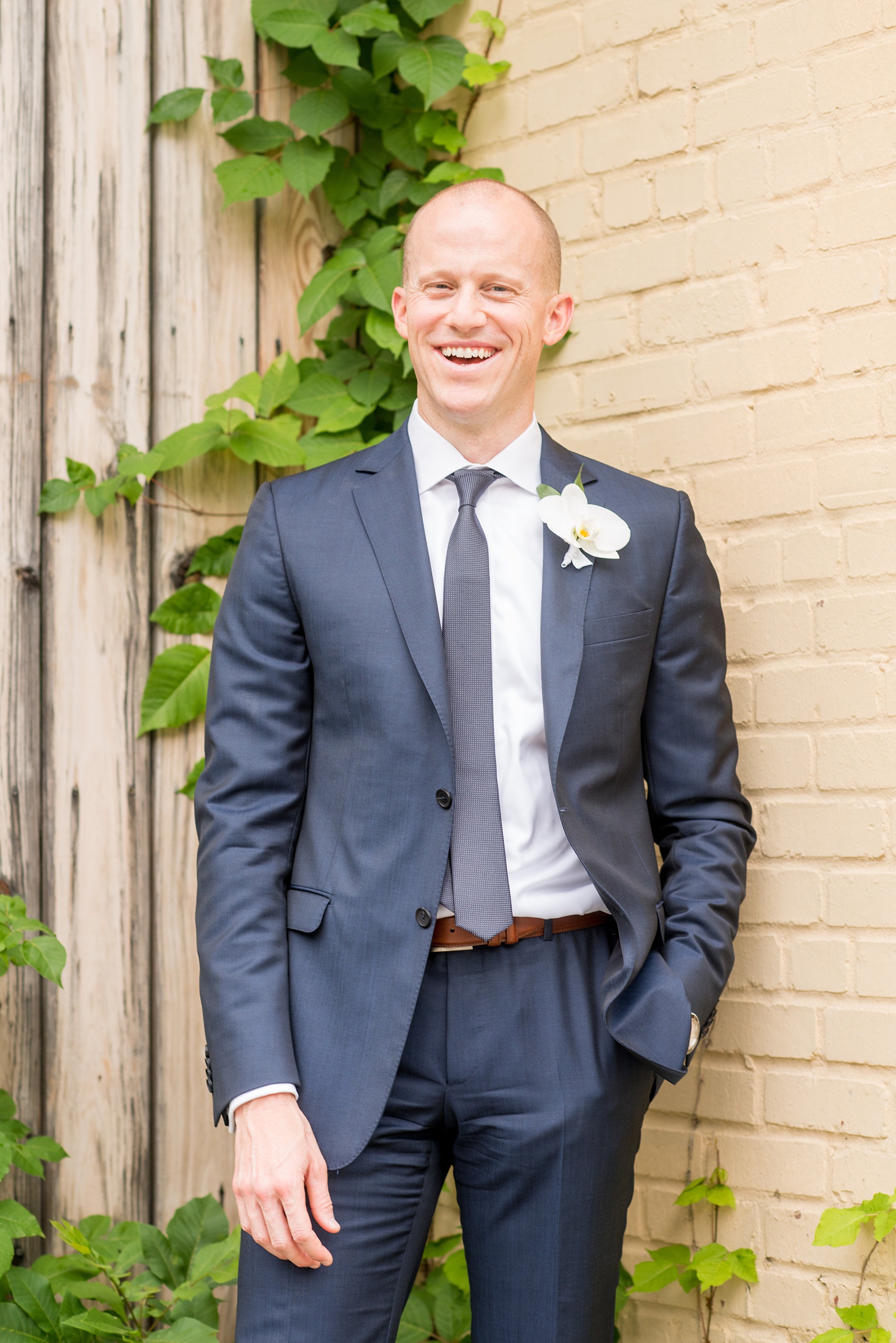 The Cookery Durham wedding photos by Mikkel Paige Photography. Picture of the groom in a navy blue suit and white orchid boutonniere.