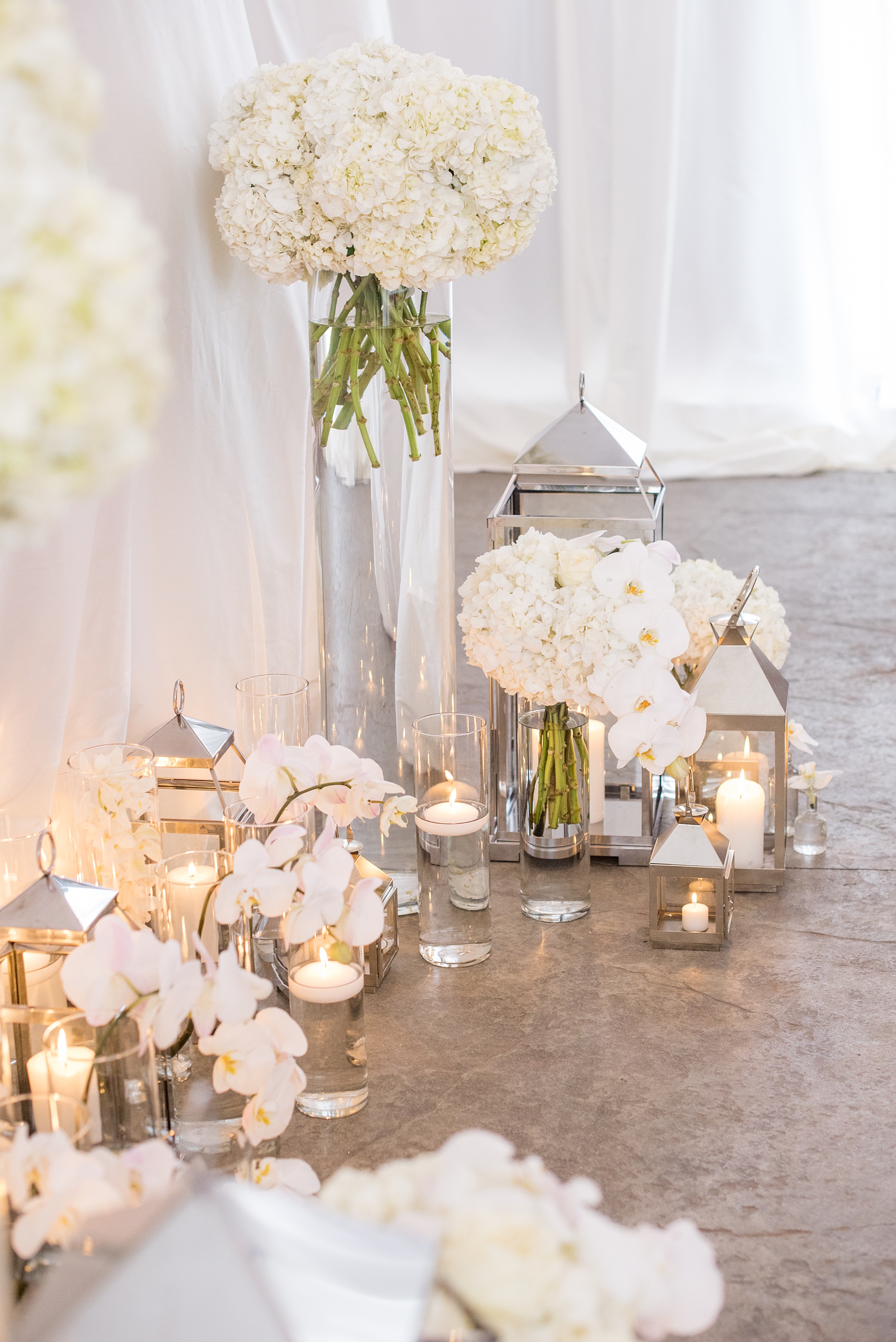 The Cookery Durham wedding photos by Mikkel Paige Photography. Picture of the tented ceremony with candlelight and white flowers including orchids and hydrangeas.