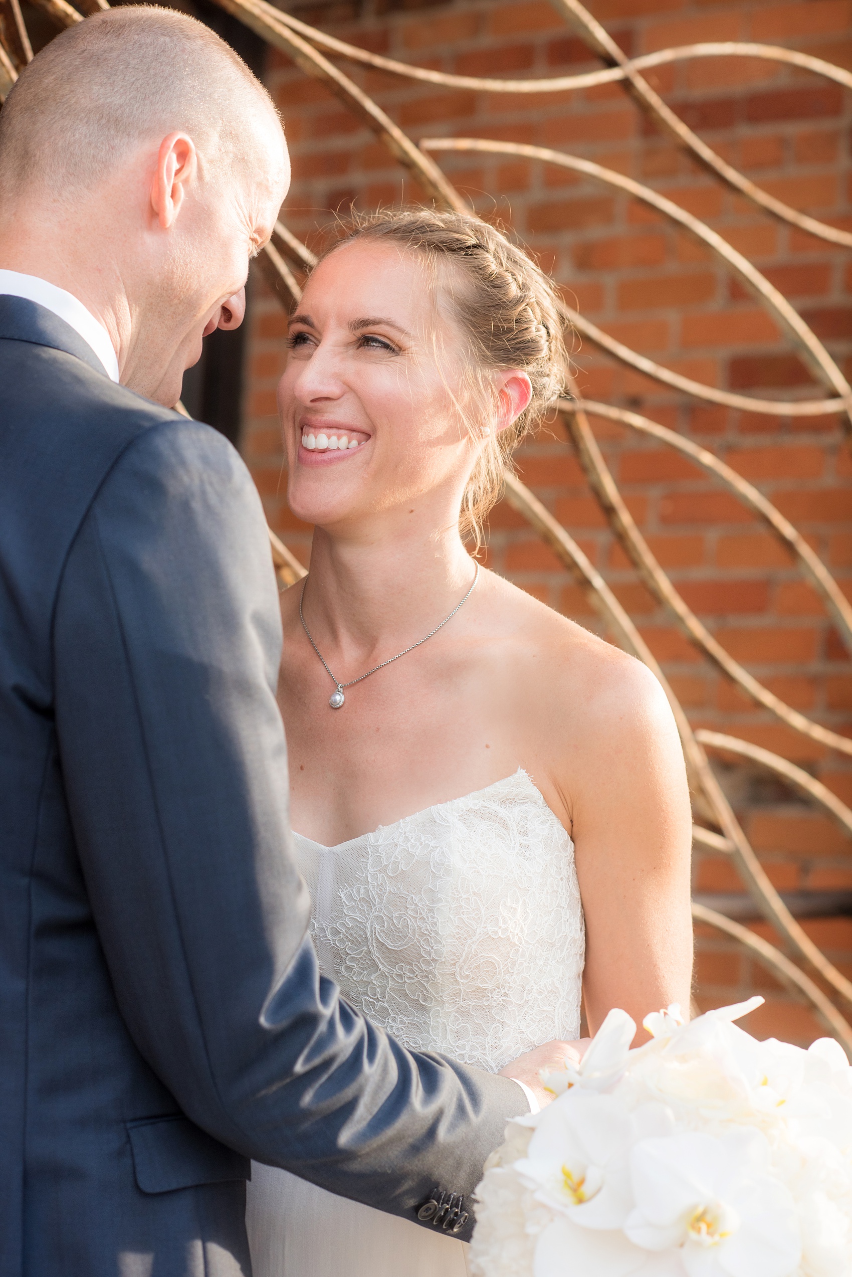 The Cookery Durham wedding photos by Mikkel Paige Photography. The bride and groom laugh in front of a rustic iron gate.