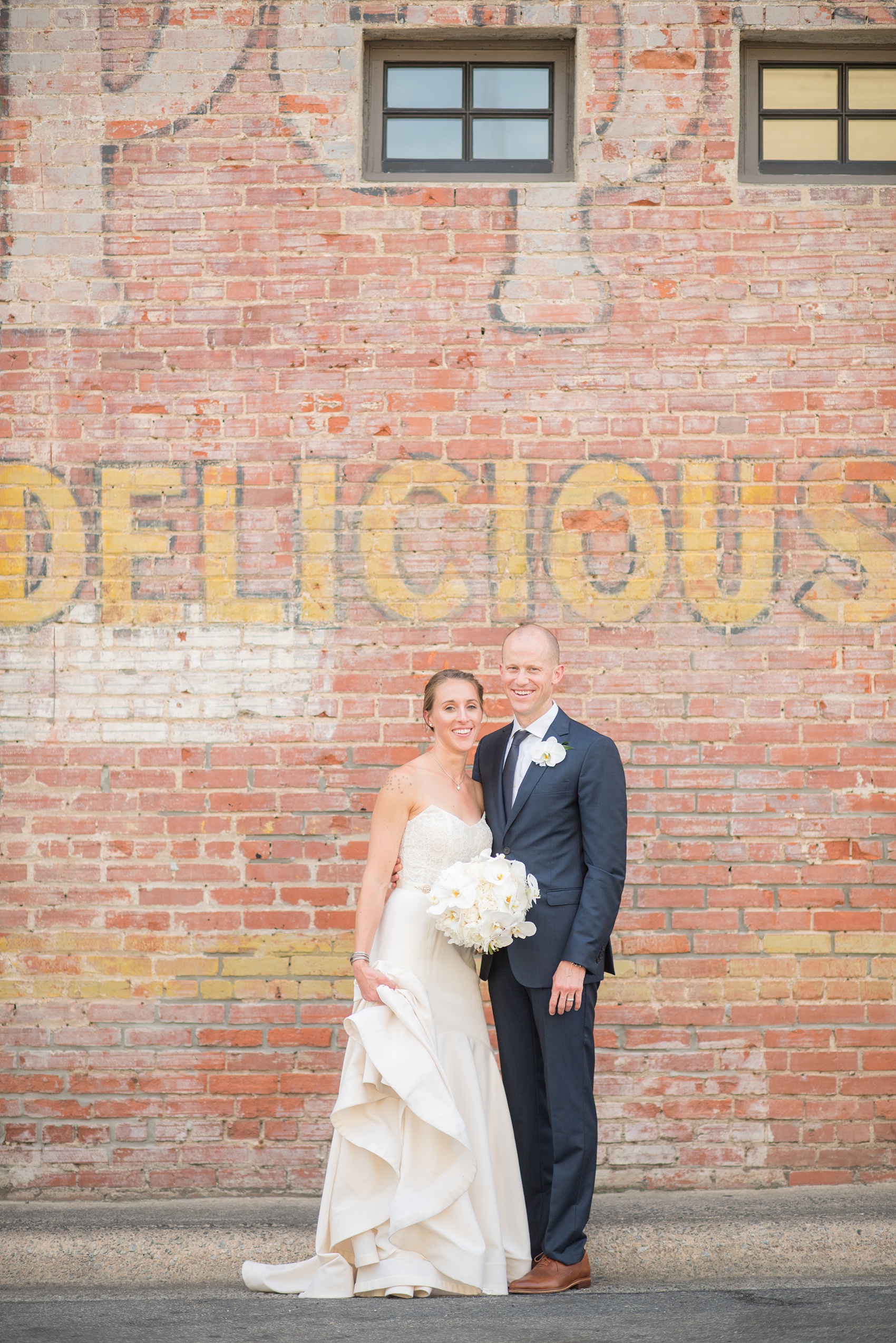 The Cookery Durham wedding photos by Mikkel Paige Photography. Picture of the bride and groom against an urban, vintage painted wall.