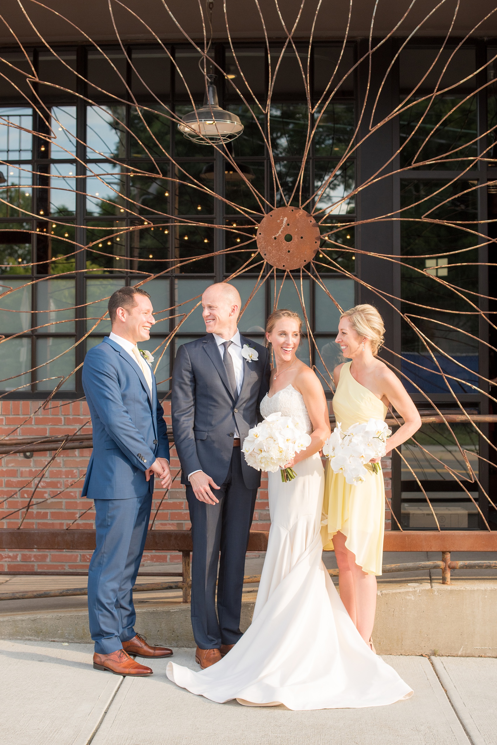 The Cookery Durham wedding photos by Mikkel Paige Photography. Picture of the small wedding party of 4 - bridesmaid in yellow and men in navy blue suits. The bride wore a strapless wedding gown. 