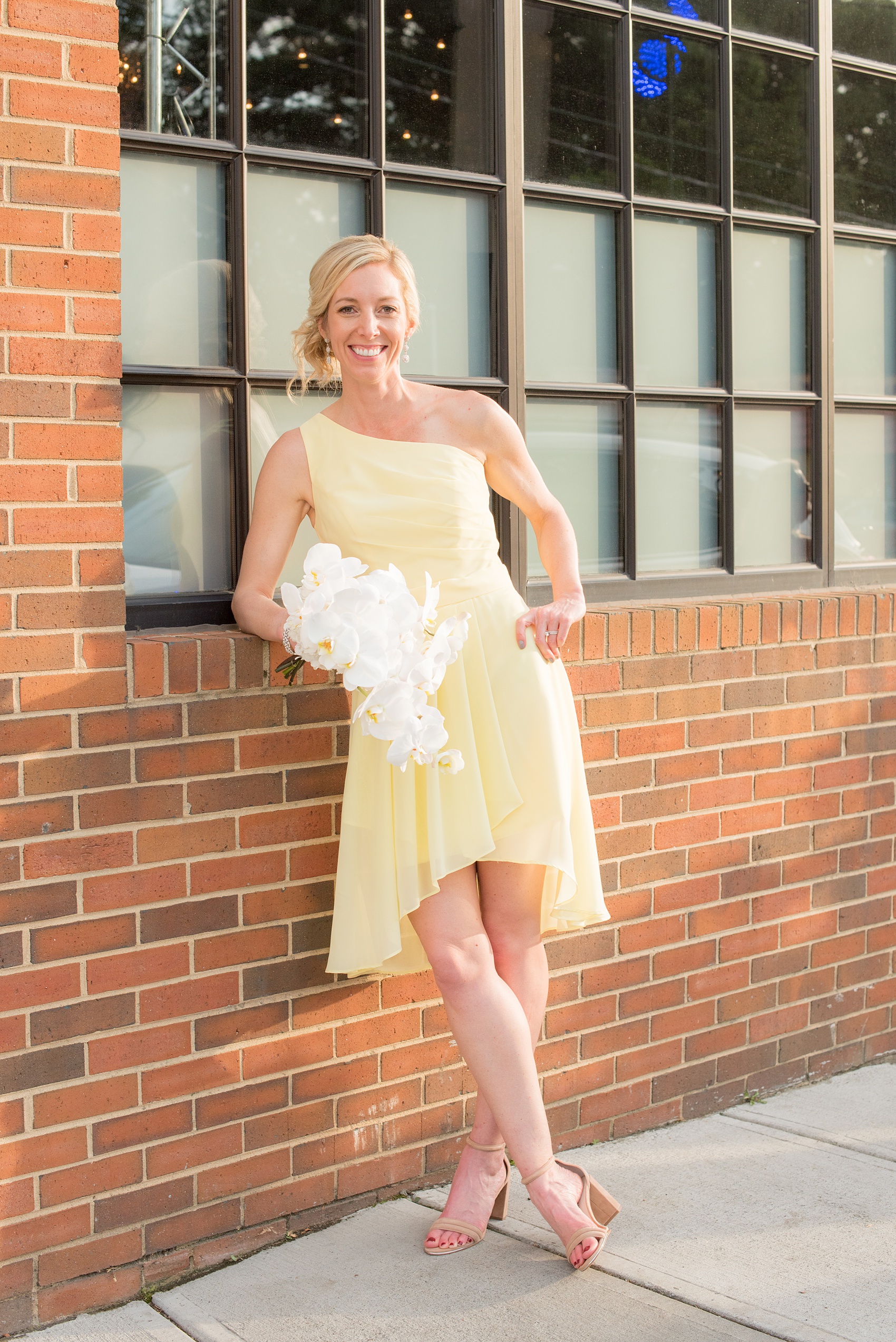 The Cookery Durham wedding photos by Mikkel Paige Photography. Picture of the Maid of Honor in a yellow one-shoulder dress with a white orchid bouquet by Tre Bella.