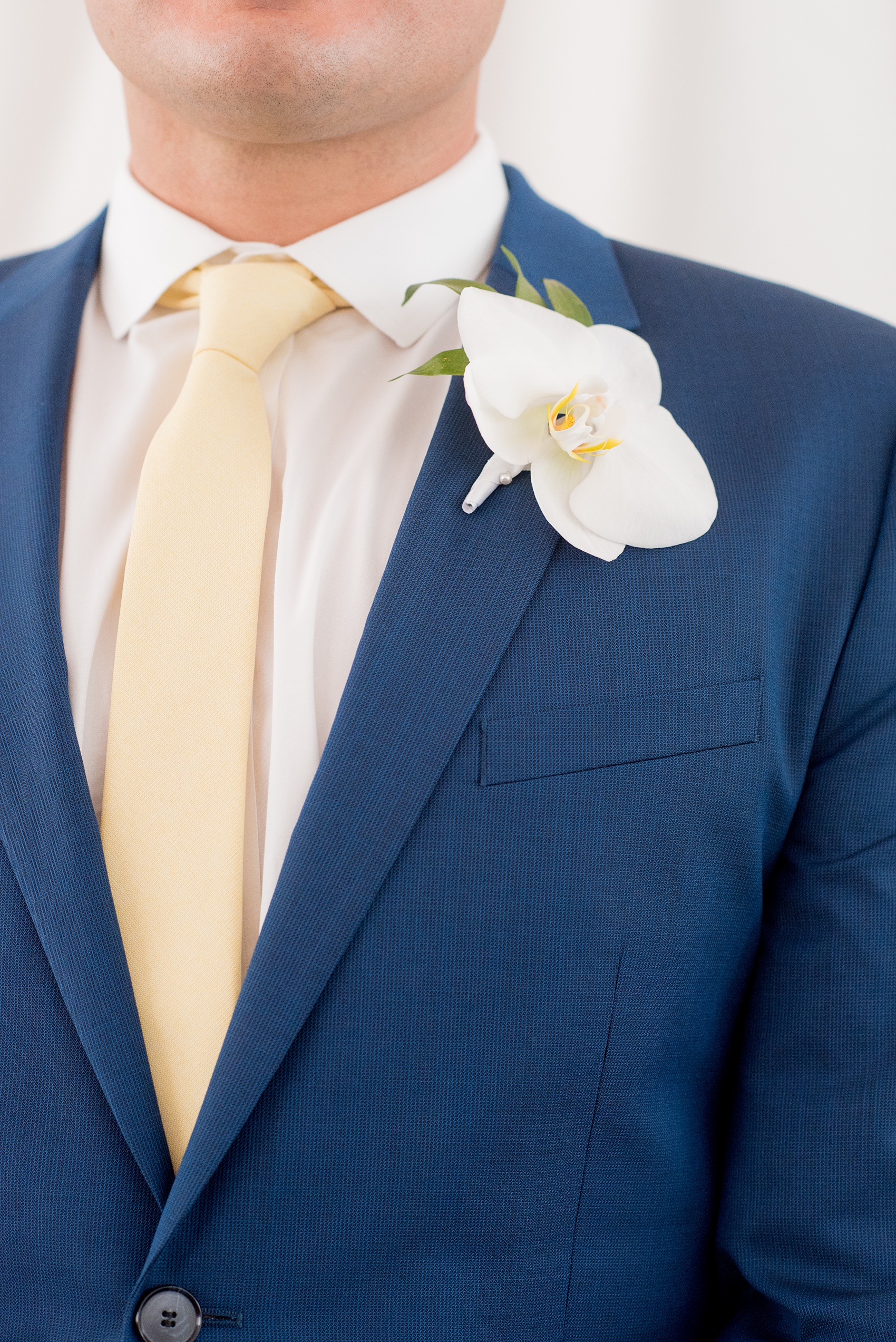 The Cookery Durham wedding photos by Mikkel Paige Photography. Picture of the groomsman's blue suit, yellow tie and white orchid boutonniere by Tre Bella.