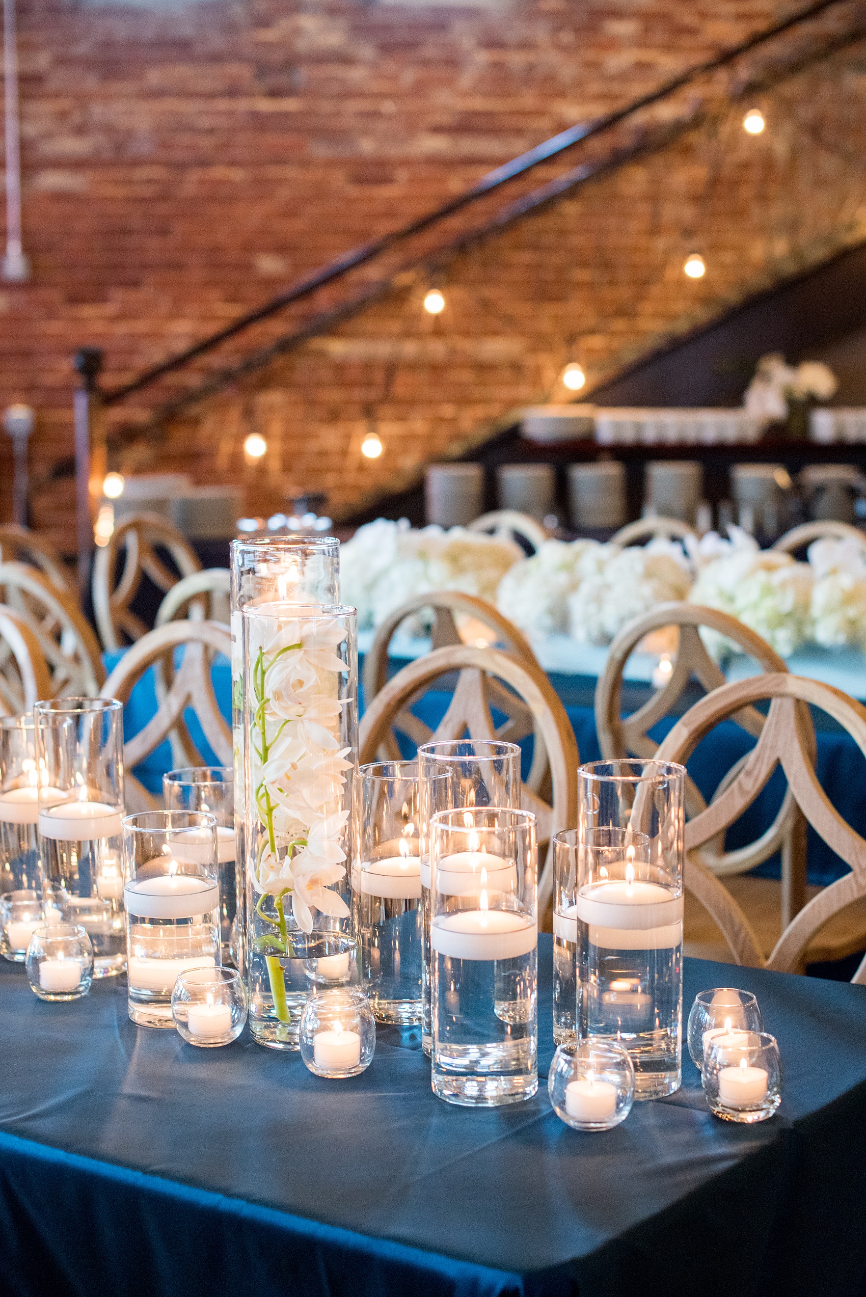 The Cookery Durham wedding photos by Mikkel Paige Photography. Picture of the teal and neutral colored wood palette by Erin McLean Events. Candlelight and rectangular tables were the seating for guests in this charming venue.