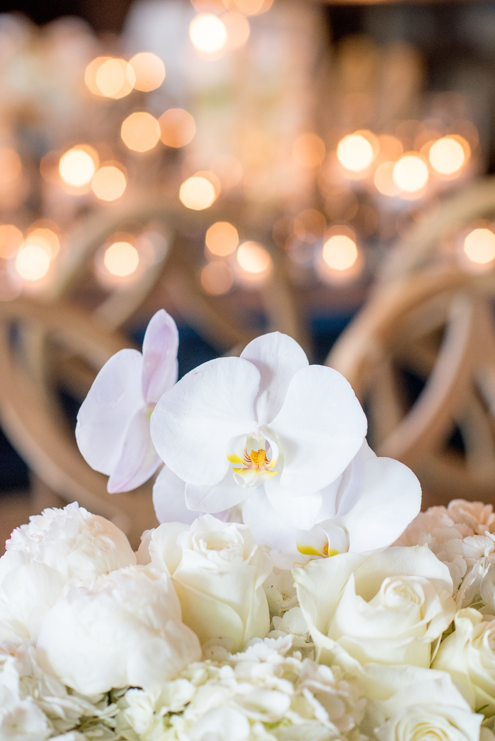 The Cookery Durham wedding photos by Mikkel Paige Photography. Picture of the teal and neutral colored wood palette by Erin McLean Events. Candlelight and rectangular tables were the seating for guests in this charming venue. Flower boxes by Tre Bella included hydrangeas, peonies and white orchids.