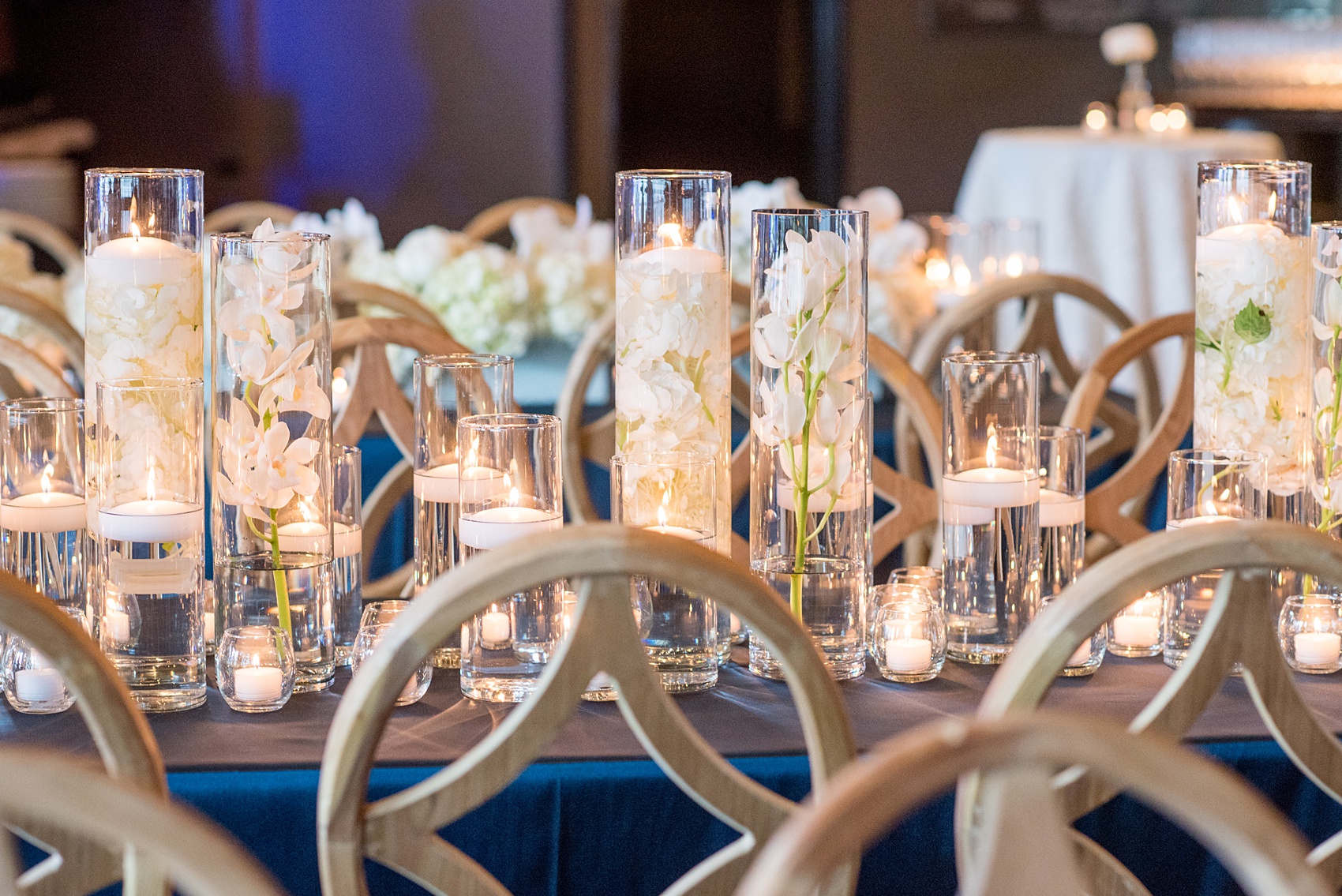 The Cookery Durham wedding photos by Mikkel Paige Photography. Picture of the teal and neutral colored wood palette by Erin McLean Events. Candlelight and rectangular tables were the seating for guests in this charming venue. Flower boxes by Tre Bella included hydrangeas, peonies and white orchids.