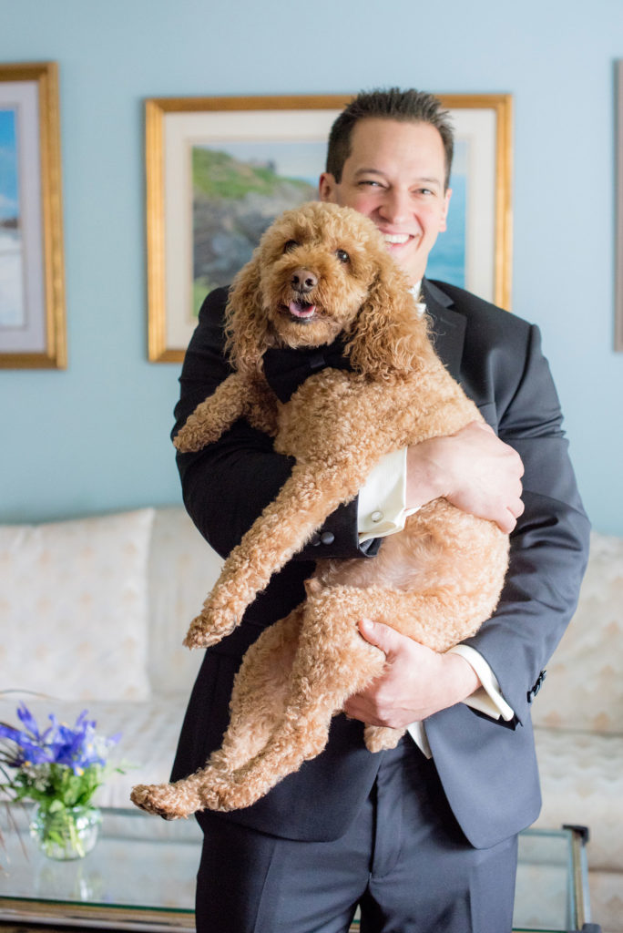 Mikkel Paige Photography wedding photos at The Fox Hollow, Long Island. A picture of the groom getting ready with his dog in a bow tie.