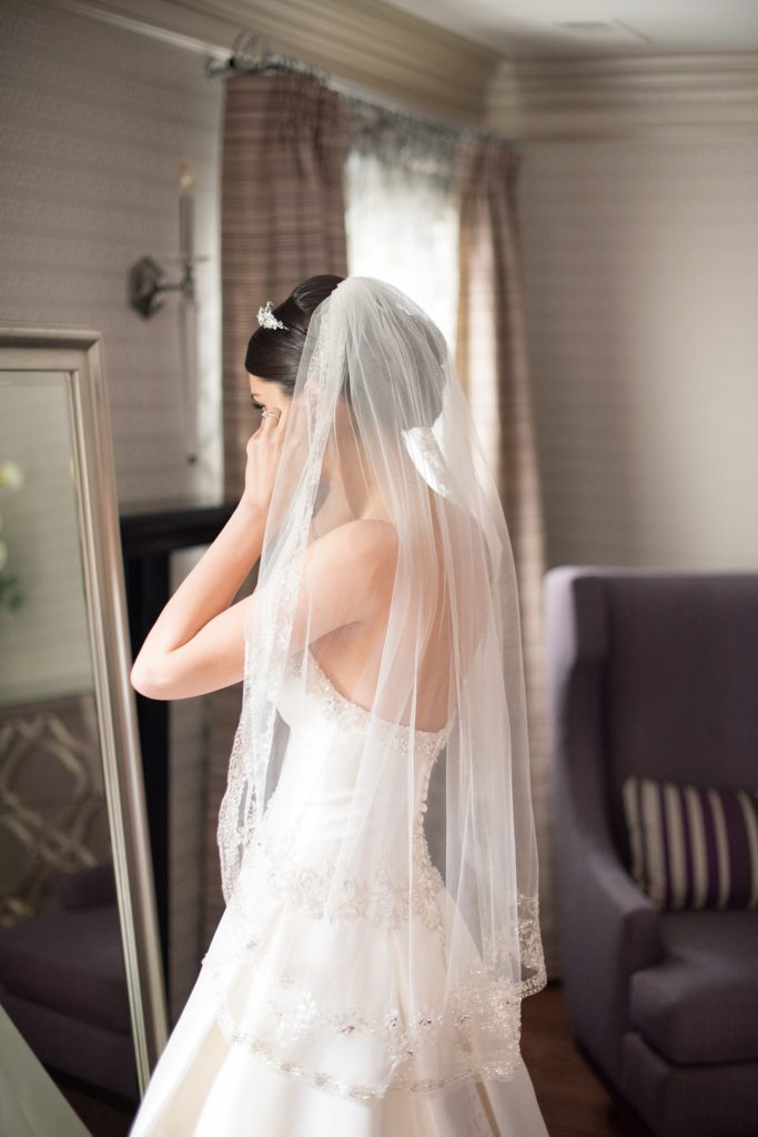 Mikkel Paige Photography wedding photos at The Fox Hollow, Long Island. A candid picture of the bride getting ready for the ceremony.