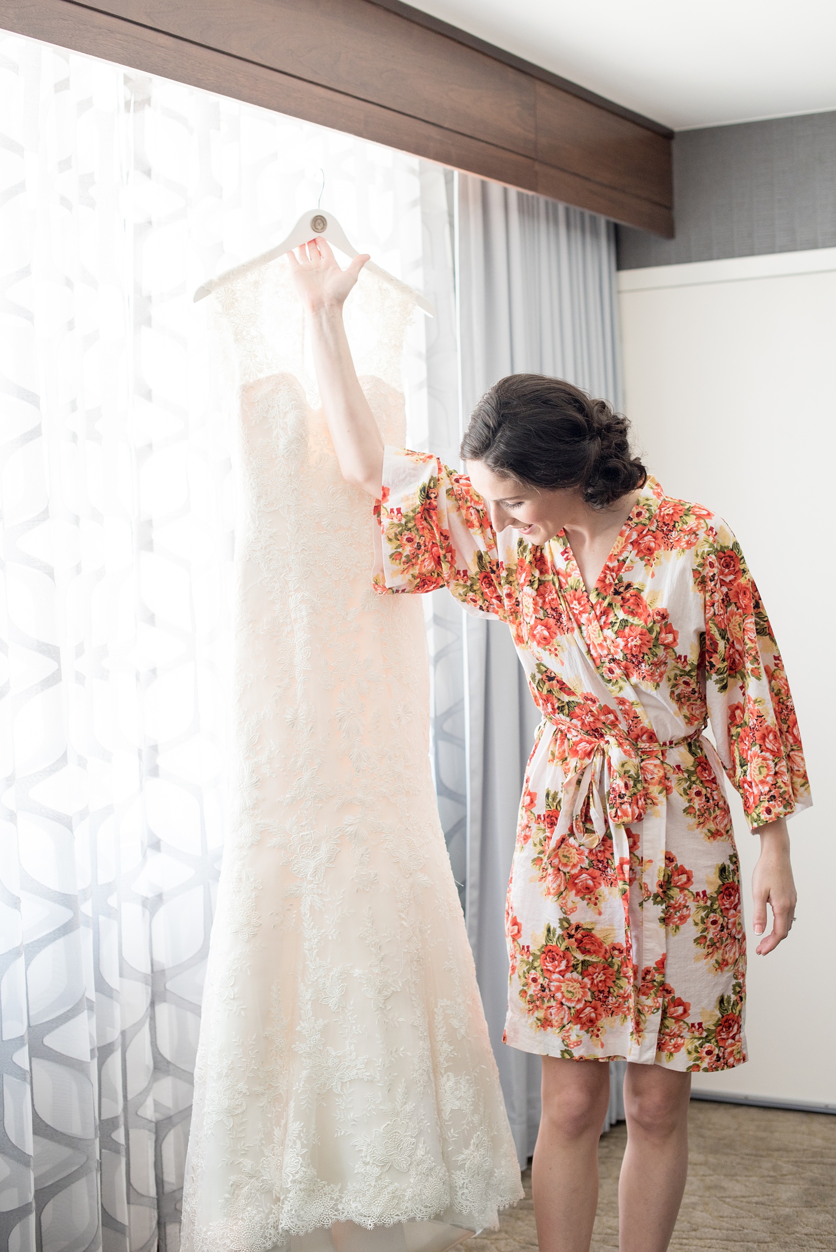 Pavilion at Angus Barn wedding photos by Mikkel Paige Photography. Picture of the bride getting ready in her lace wedding gown by Justin Alexander from Maggi Bridal.