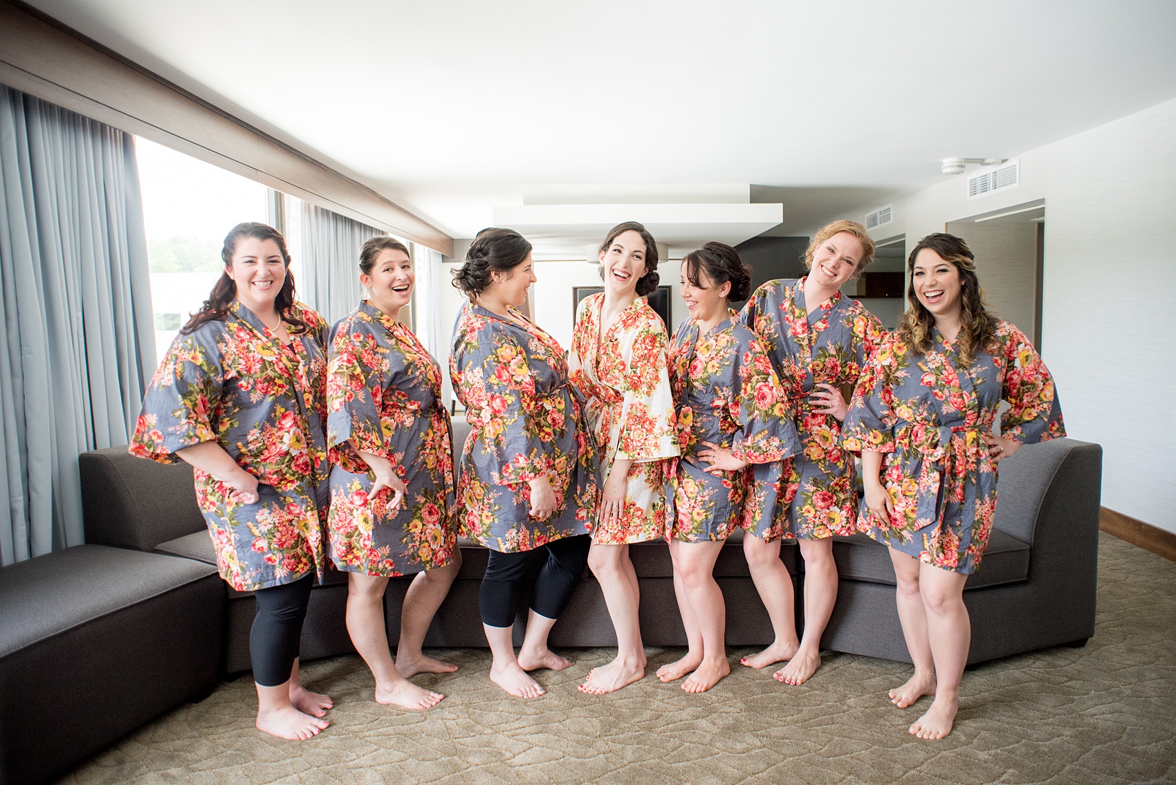 Pavilion at Angus Barn wedding photos by Mikkel Paige Photography. Picture of the bridesmaids getting ready in white and lavender floral robes.