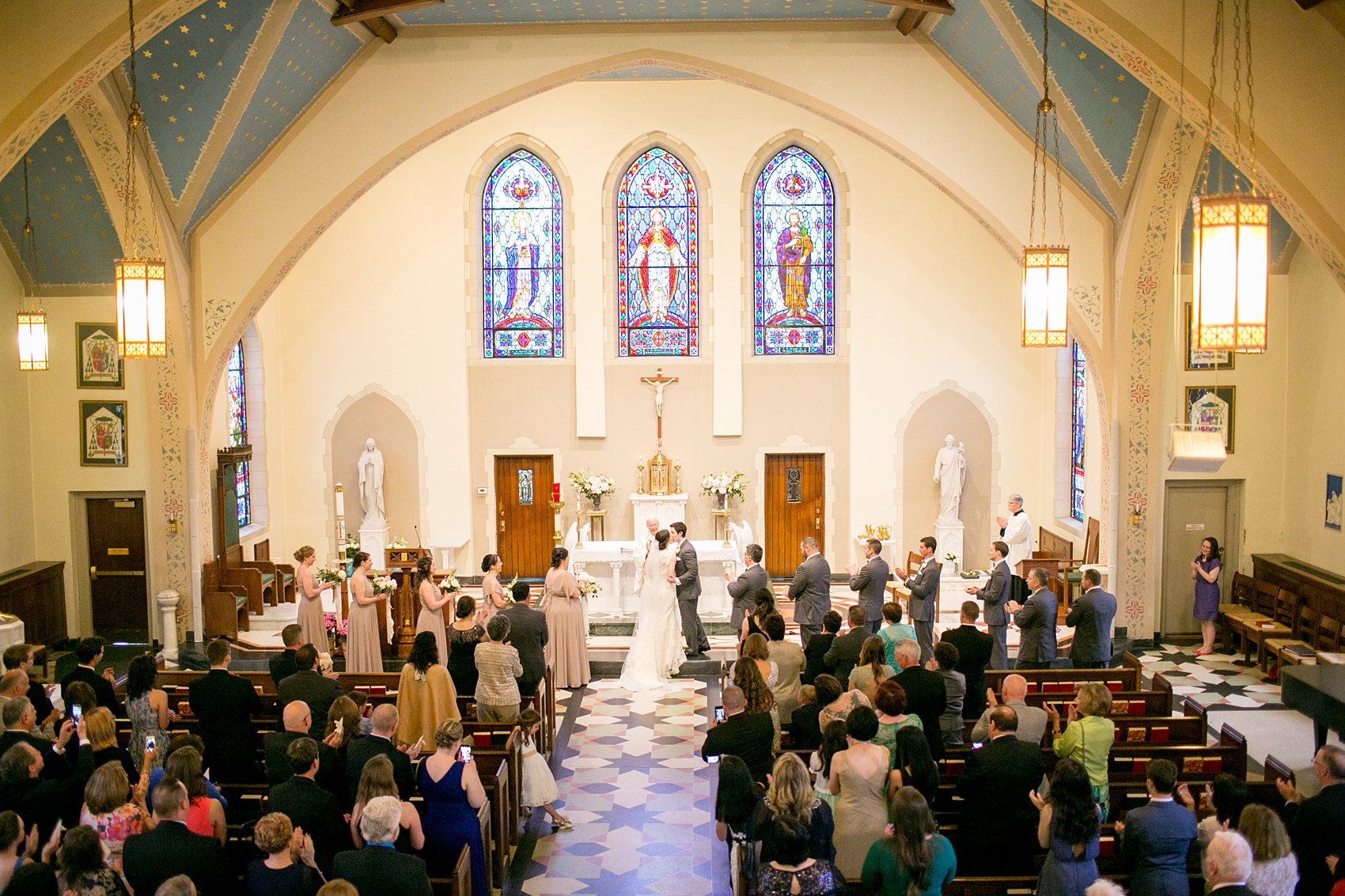 Wedding photos by Mikkel Paige Photography at Sacred Heart Cathedral in downtown Raleigh of the bride and groom's first kiss.