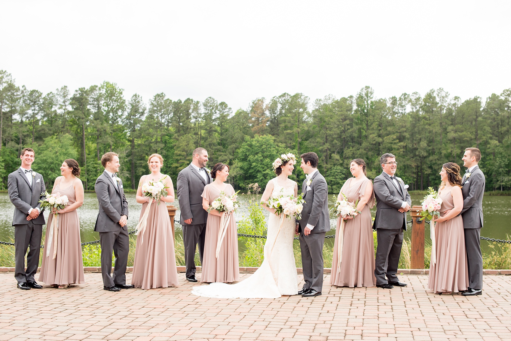 Pavilion at Angus Barn wedding photos by Mikkel Paige Photography. Unique picture of the wedding party with the bridesmaids in dusty rose mismatched chiffon Jenny Yoo gowns and the groomsmen in grey suits.