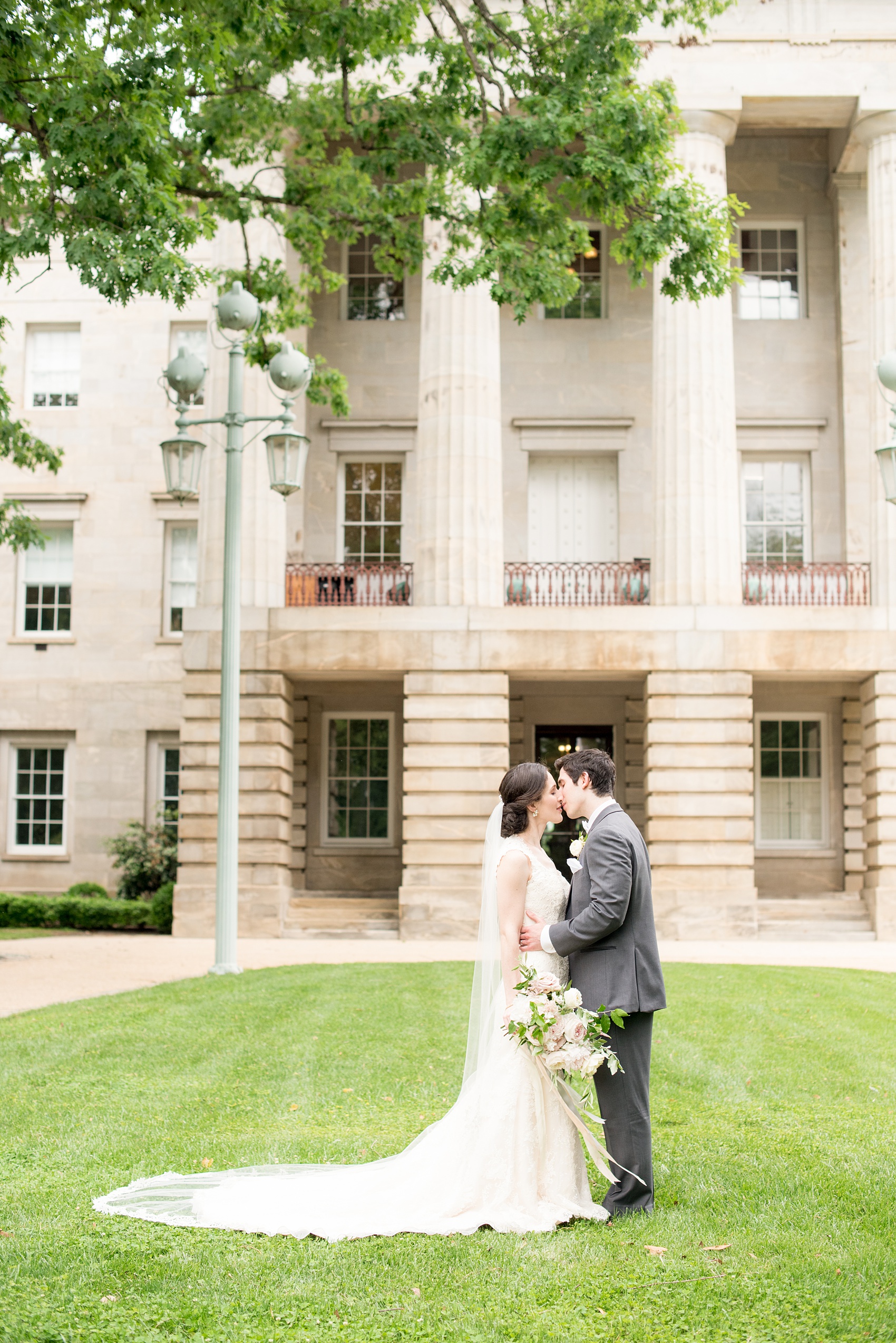 Pavilion at Angus Barn wedding photos by Mikkel Paige Photography. Picture of the bride and groom at the Raleigh capitol building during a spring day. Flowers by Meristem Floral.