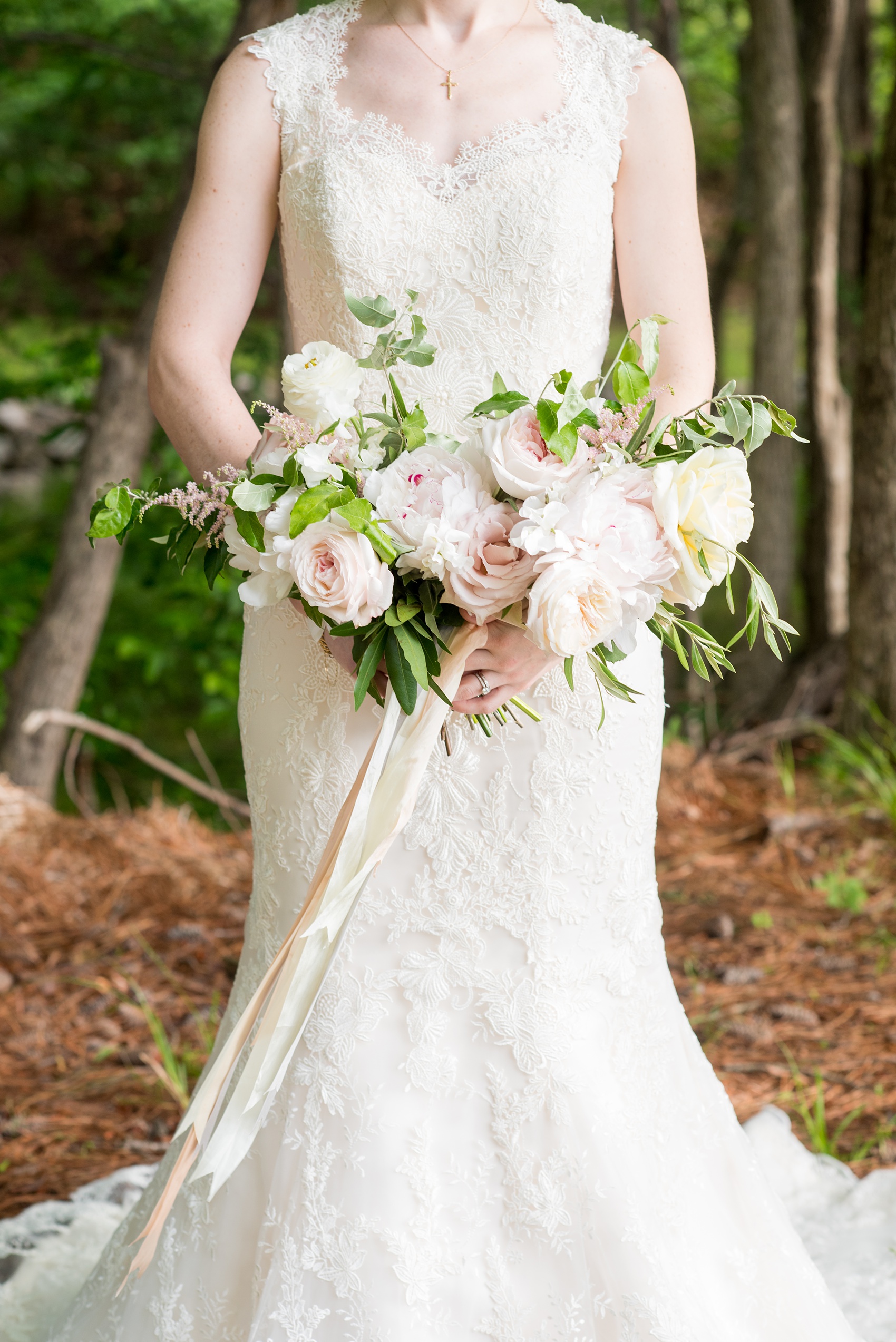 Pavilion at Angus Barn wedding photos by Mikkel Paige Photography. Picture of the bride in a lace gown with her soft pink and dusty rose whimsical bouquet with silk ribbons by Meristem Floral.