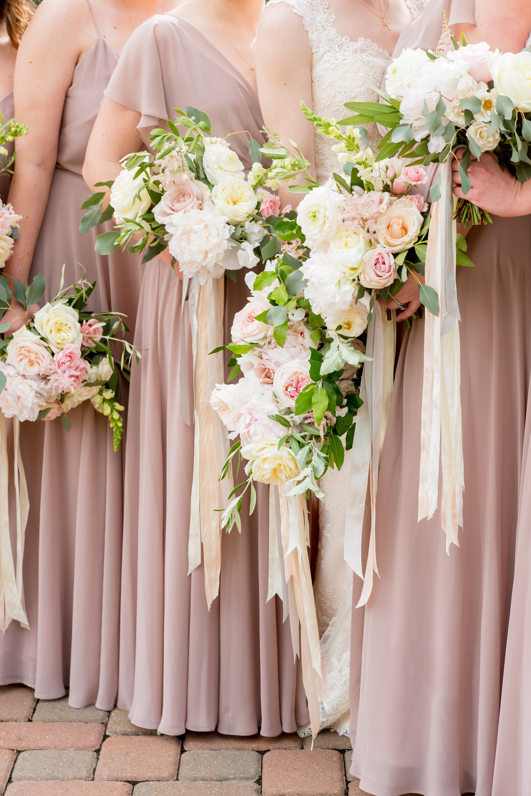 Pavilion at Angus Barn wedding photos by Mikkel Paige Photography. Picture of the bridesmaids whimsical bouquets in soft pink and dusty rose with silk ribbons by Meristem Floral.