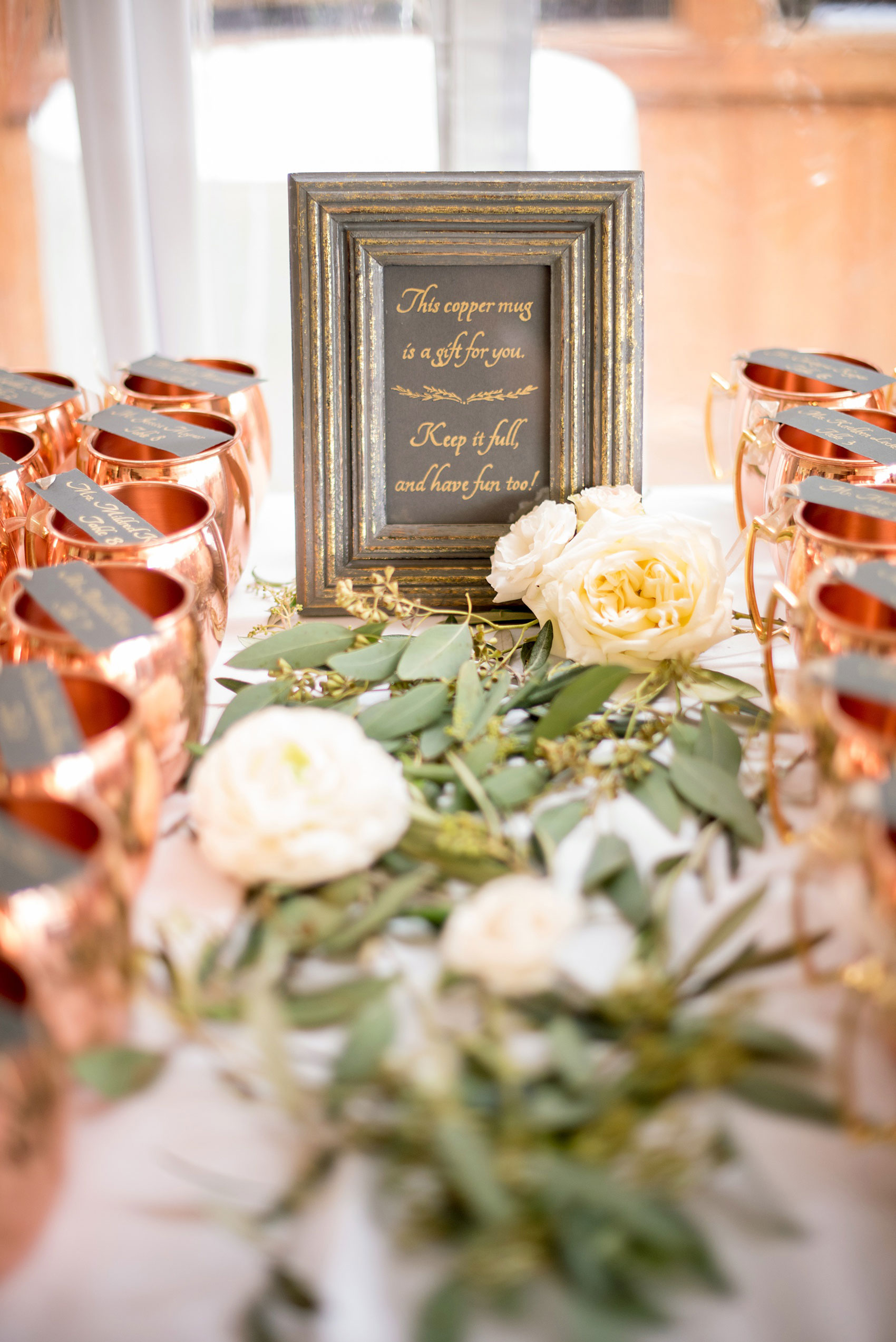 Pavilion at Angus Barn wedding photos by Mikkel Paige Photography. Detail picture of the escort cards attached to copper mugs that doubled as guest favors.