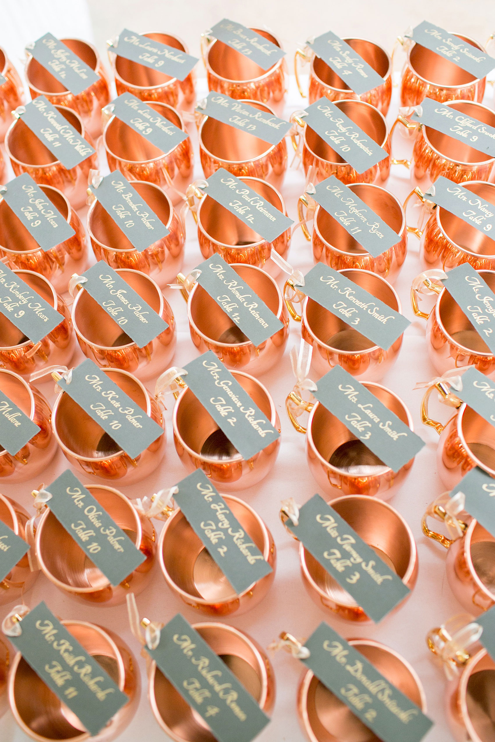 Pavilion at Angus Barn wedding photos by Mikkel Paige Photography. Detail picture of the escort cards attached to copper mugs that doubled as guest favors.