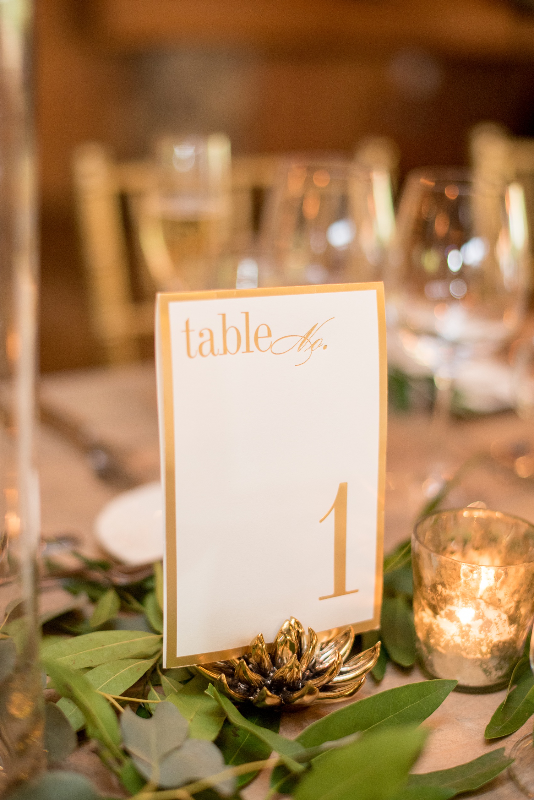 Pavilion at Angus Barn wedding photos by Mikkel Paige Photography. Picture of the classic gold table numbers.