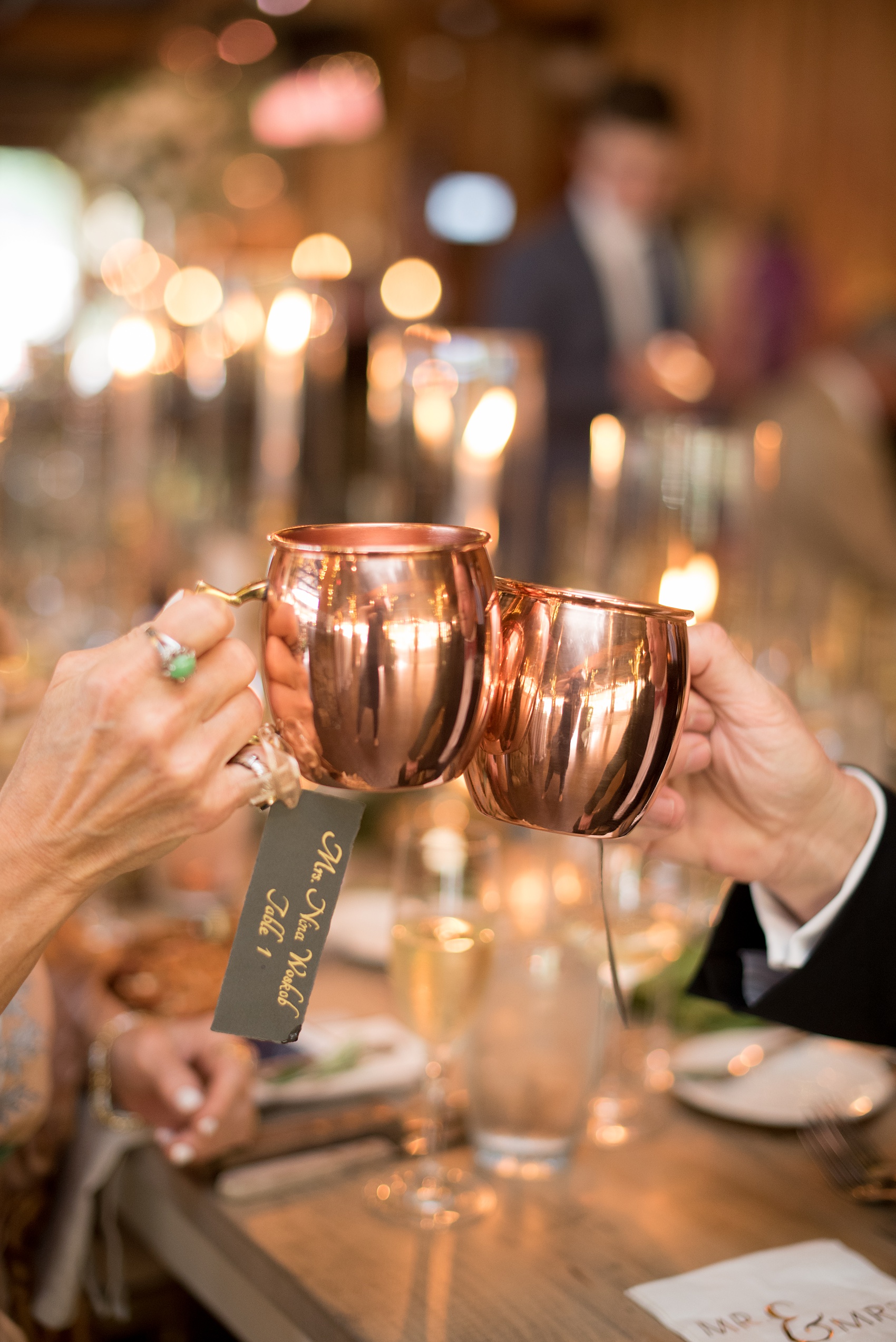 Pavilion at Angus Barn wedding photos by Mikkel Paige Photography. Picture of guests toasting with custom copper mugs.