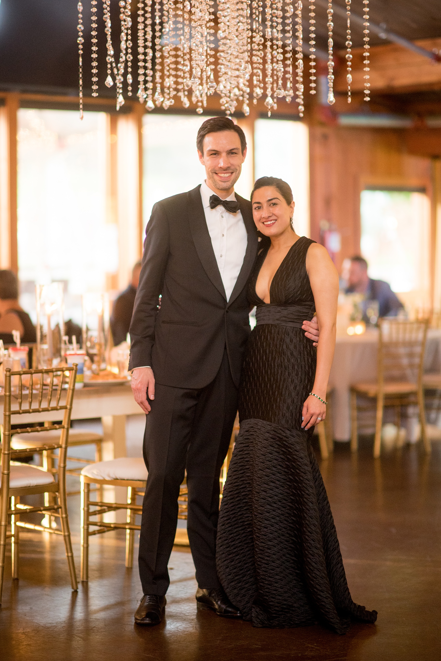 Pavilion at Angus Barn wedding photos by Mikkel Paige Photography. Picture of a couple at the reception in black tie attire.