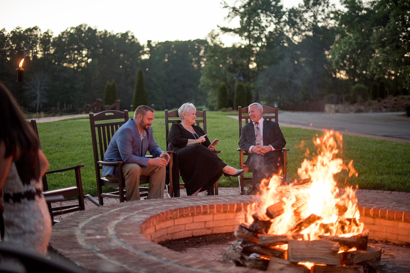 Pavilion at Angus Barn wedding photos by Mikkel Paige Photography. Picture of the guests enjoying the outdoor bonfire.