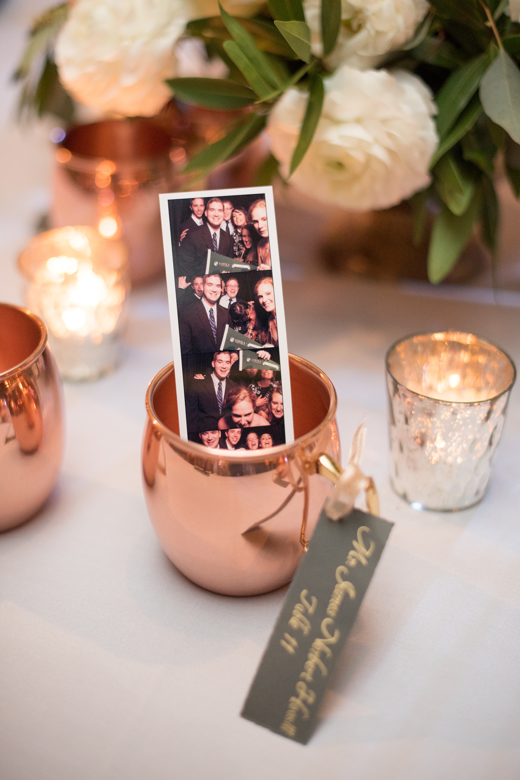 Pavilion at Angus Barn wedding photos by Mikkel Paige Photography. Candid picture of the photostrip from the reception activity in a copper mug.