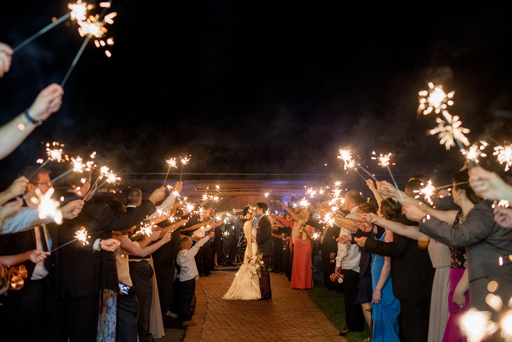 Pavilion at Angus Barn wedding photos by Mikkel Paige Photography. Picture of the bride and groom's sparkler exit.