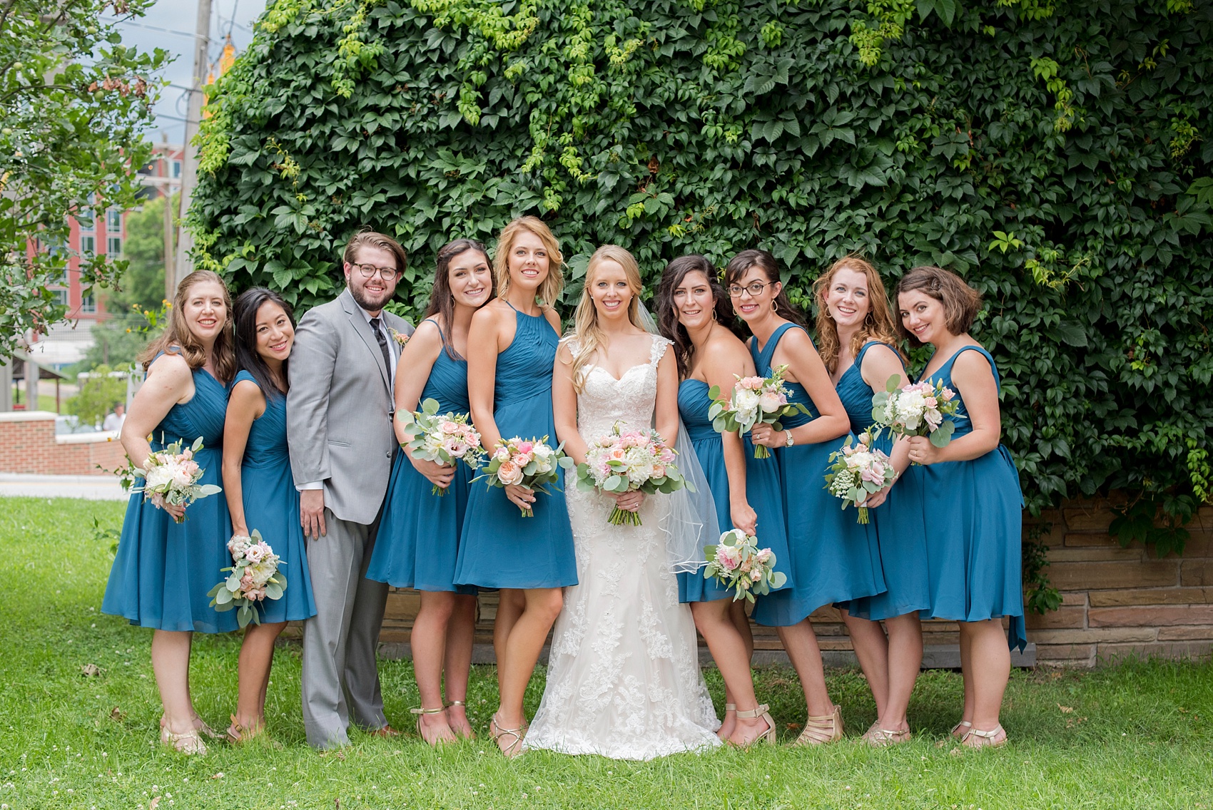 The Rickhouse Durham wedding photos by Mikkel Paige Photography. North Carolina celebration with a picture of the bridal party in teal.