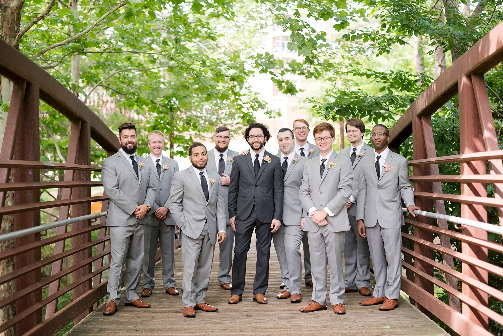 The Rickhouse Durham wedding photos by Mikkel Paige Photography. North Carolina celebration with a picture of the groomsmen on a rustic bridge downtown.