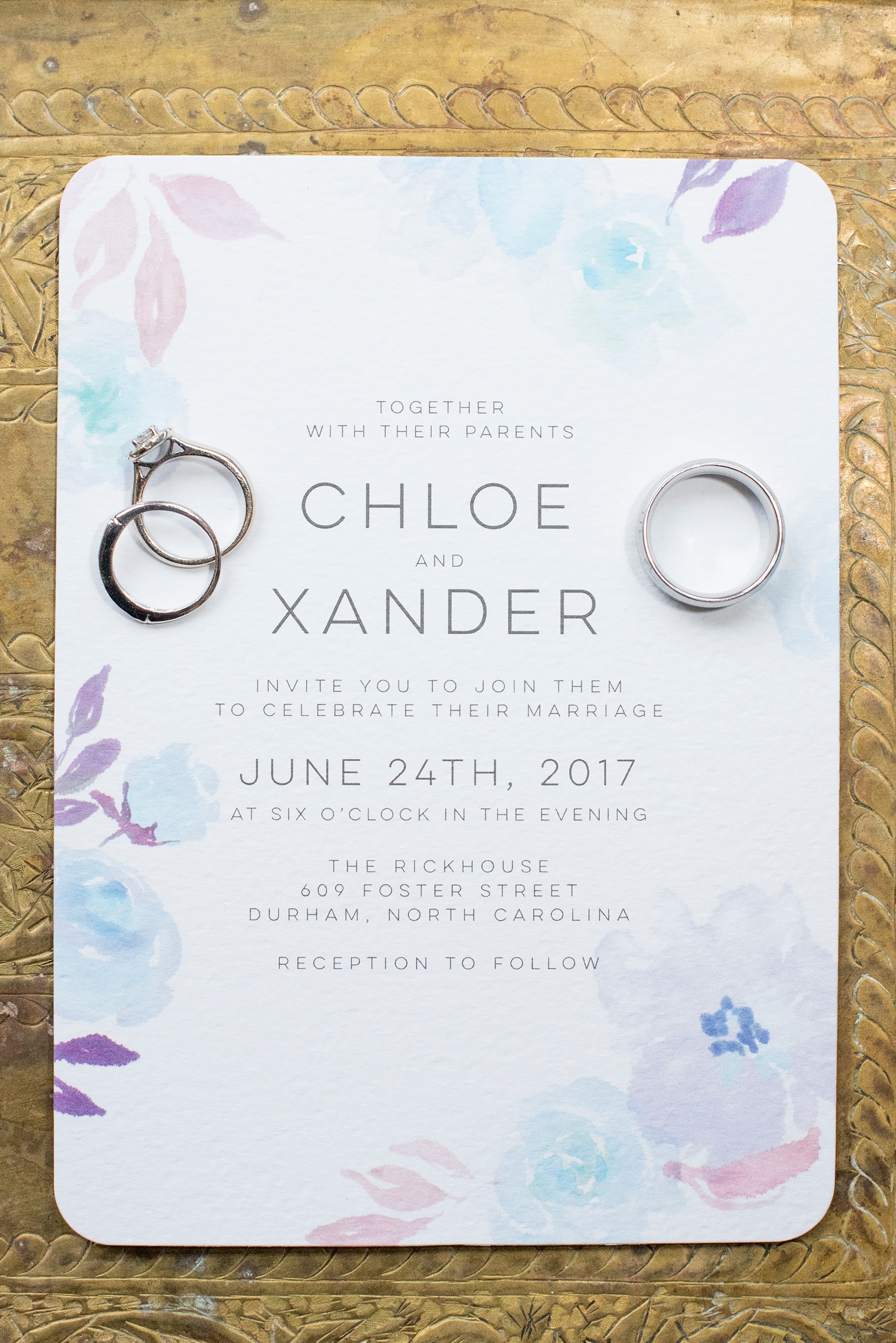 The Rickhouse Durham wedding photos by Mikkel Paige Photography. North Carolina celebration with a detail picture of the watercolor invitation and rings.
