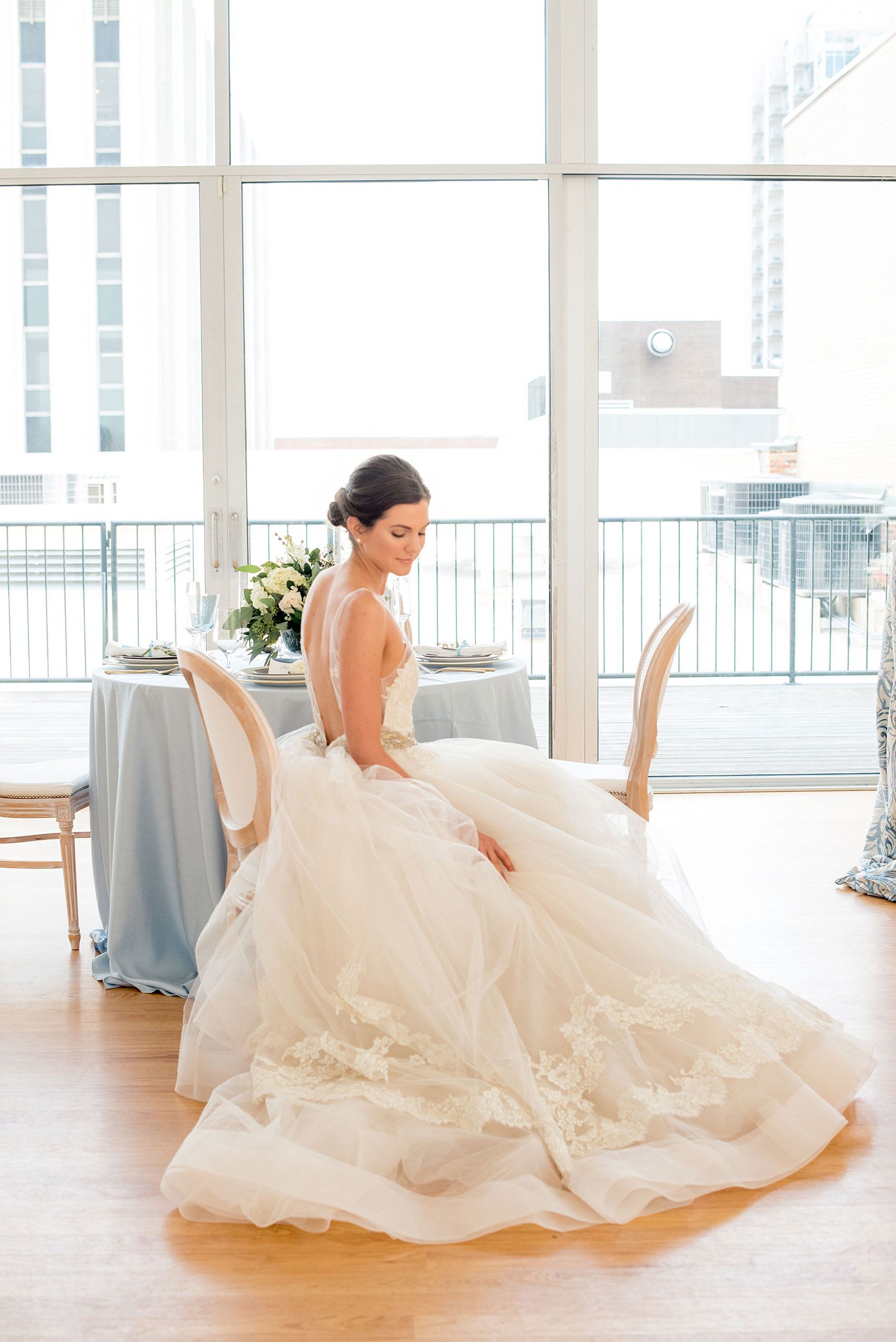 The Glass Box Raleigh wedding photos by Mikkel Paige Photography. Picture of the bride in a Lazaro gown in this modern downtown venue.