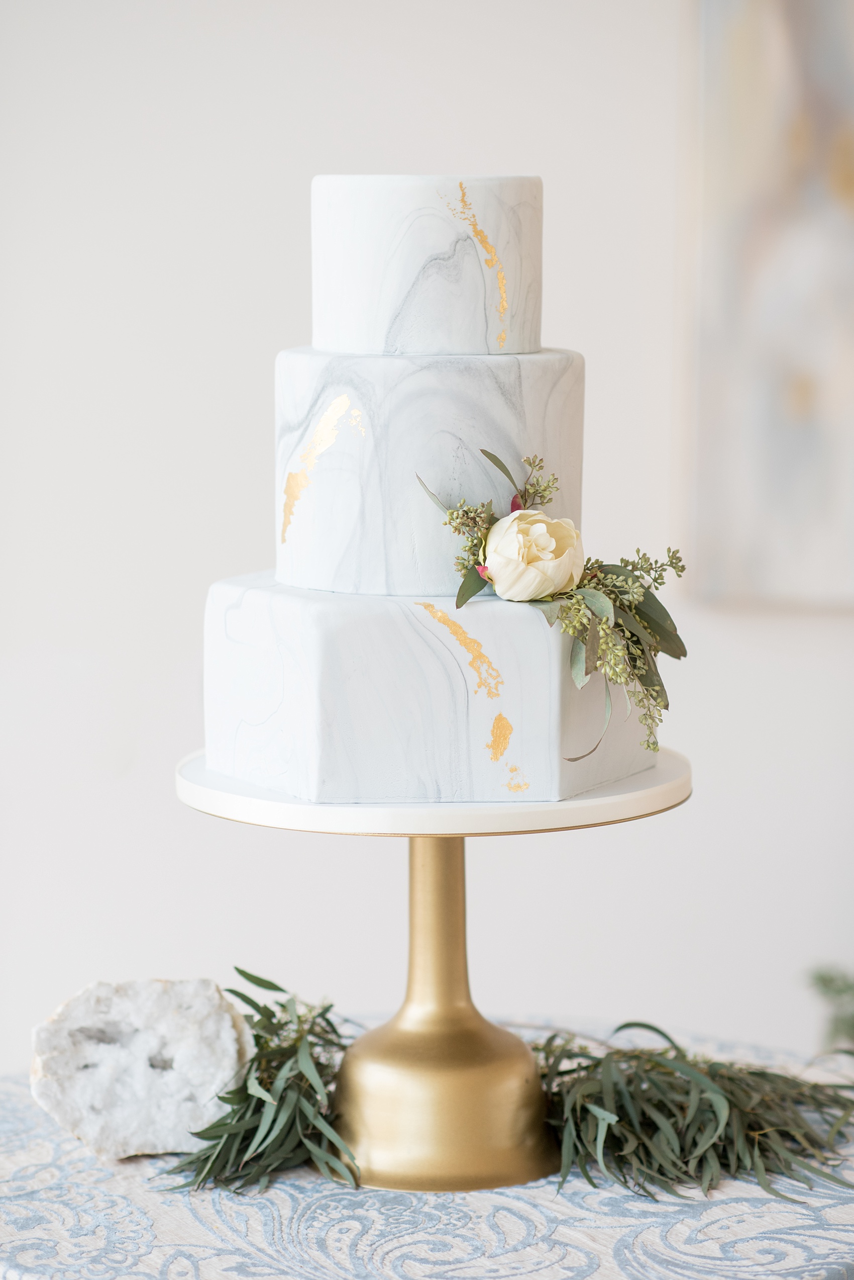 The Glass Box Raleigh wedding photos by Mikkel Paige Photography. Picture of a grey and white marble hexagonal tiered cake.