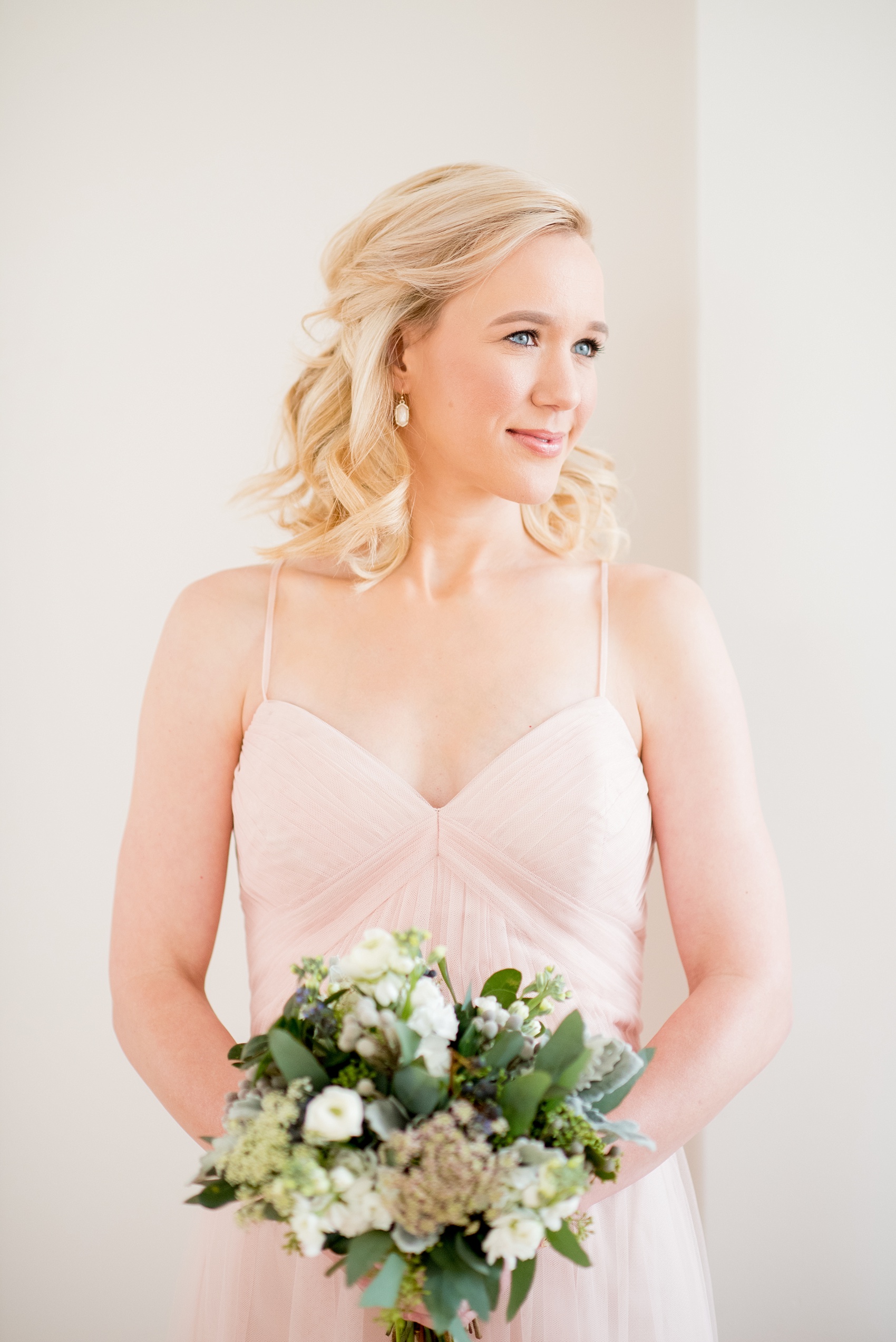 The Glass Box Raleigh wedding photos by Mikkel Paige Photography. Picture of the bridesmaid in a pink Hayley Paige occasion gown with white Kendra Scott drop earrings.